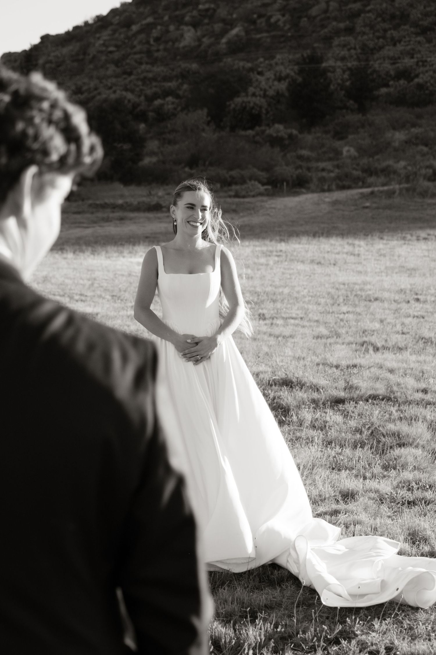 Black and white sequence showing white dress fabric flowing in an outdoor field setting.