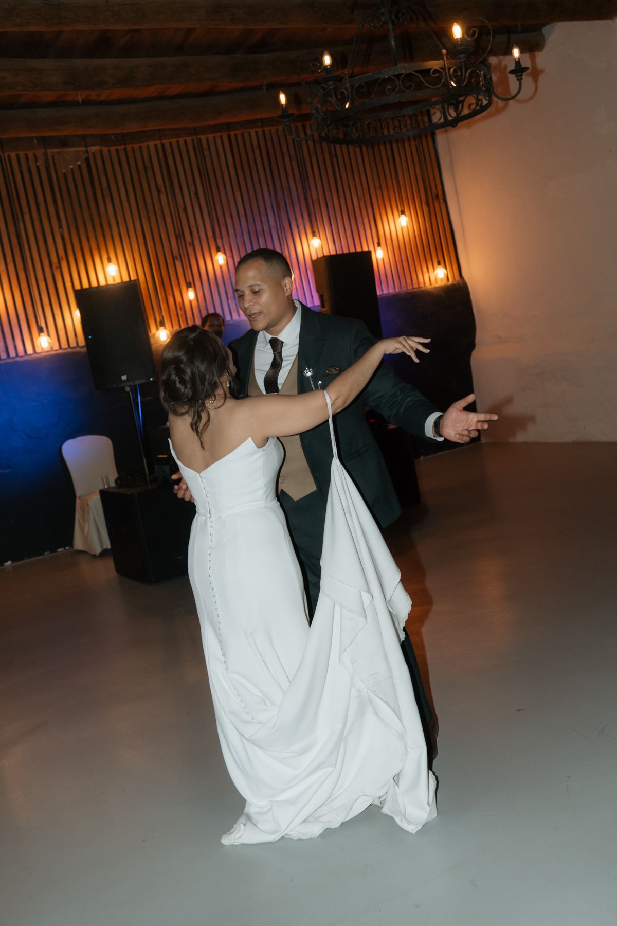 Bride and groom sharing first dance at wedding reception.