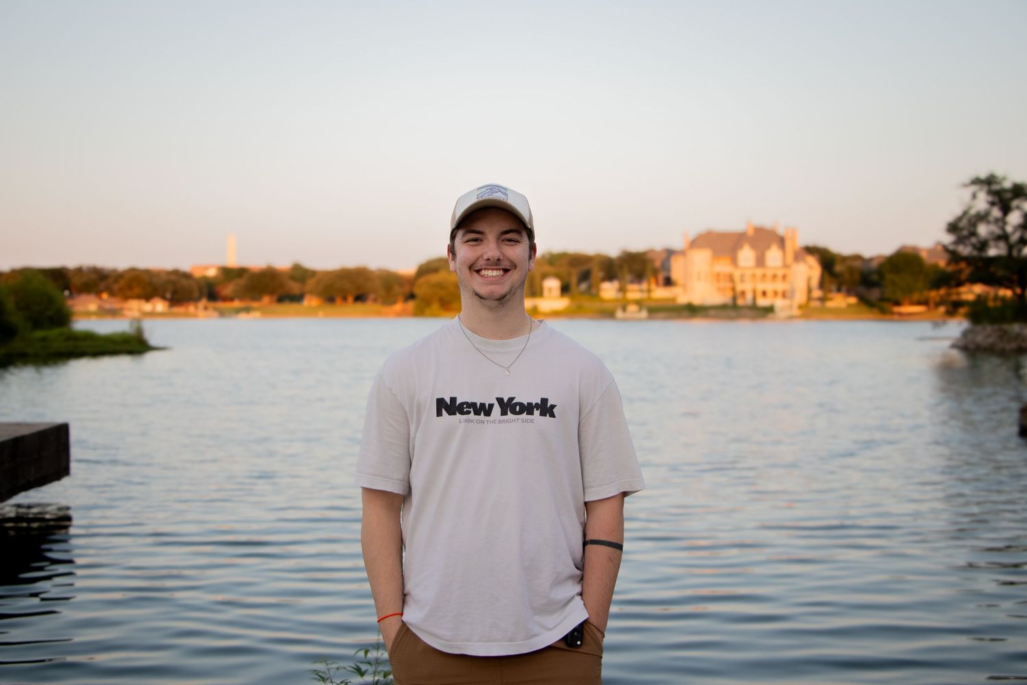 Image of Drew Easter standing in front of a lake smiling.