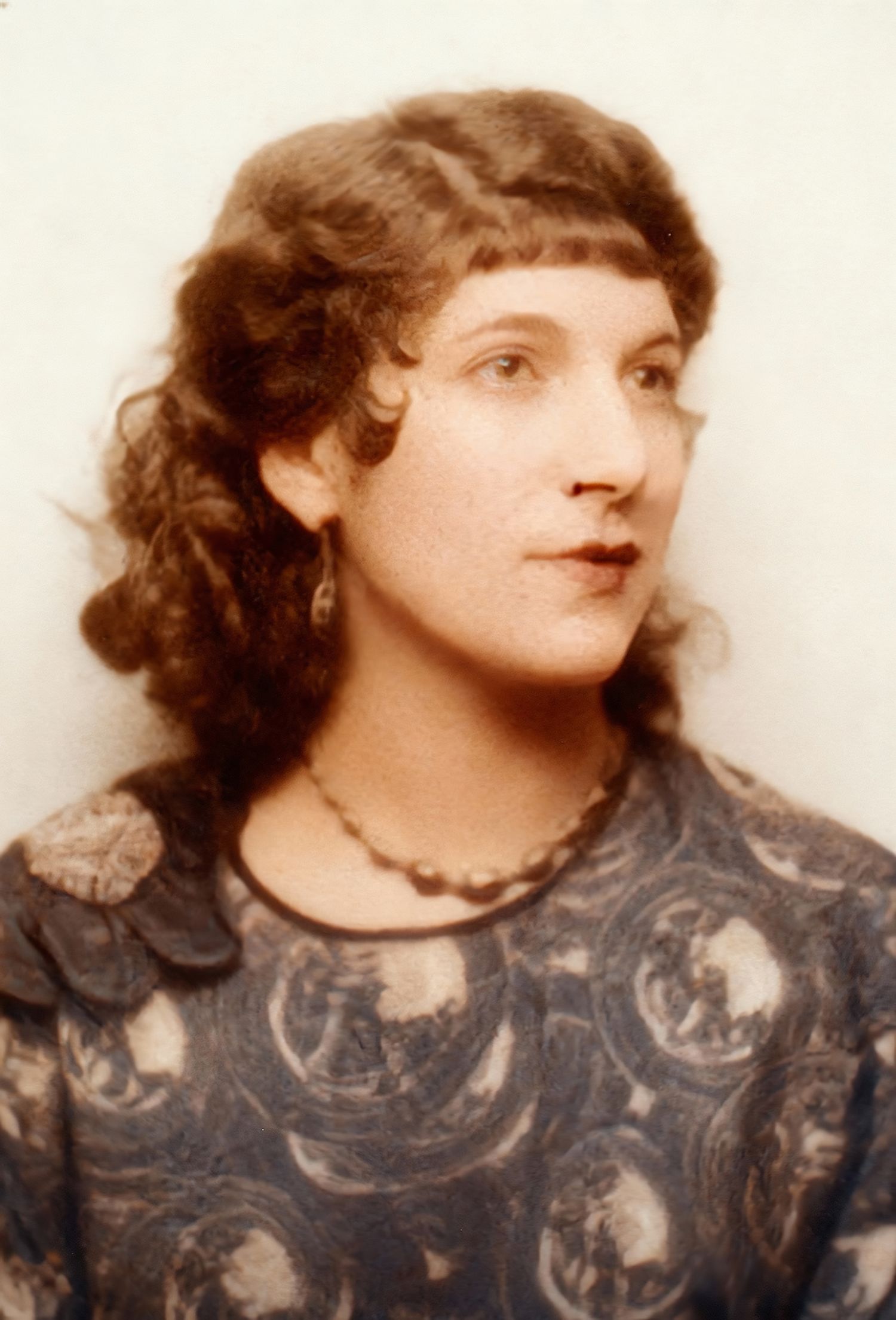 A vintage sepia-toned photo sequence showing someone in a dark patterned dress and curly hair looking to the side.