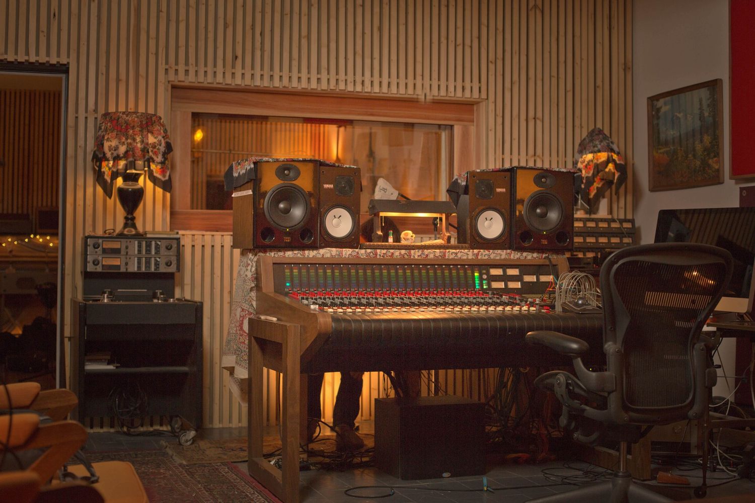 Professional recording studio interior with wood paneling and vintage equipment.
