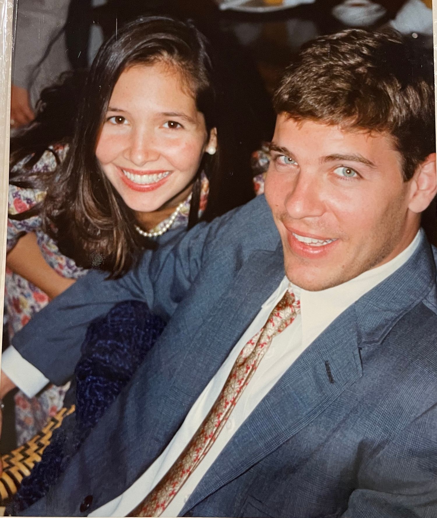 Group of people seated together at a formal event wearing business attire.