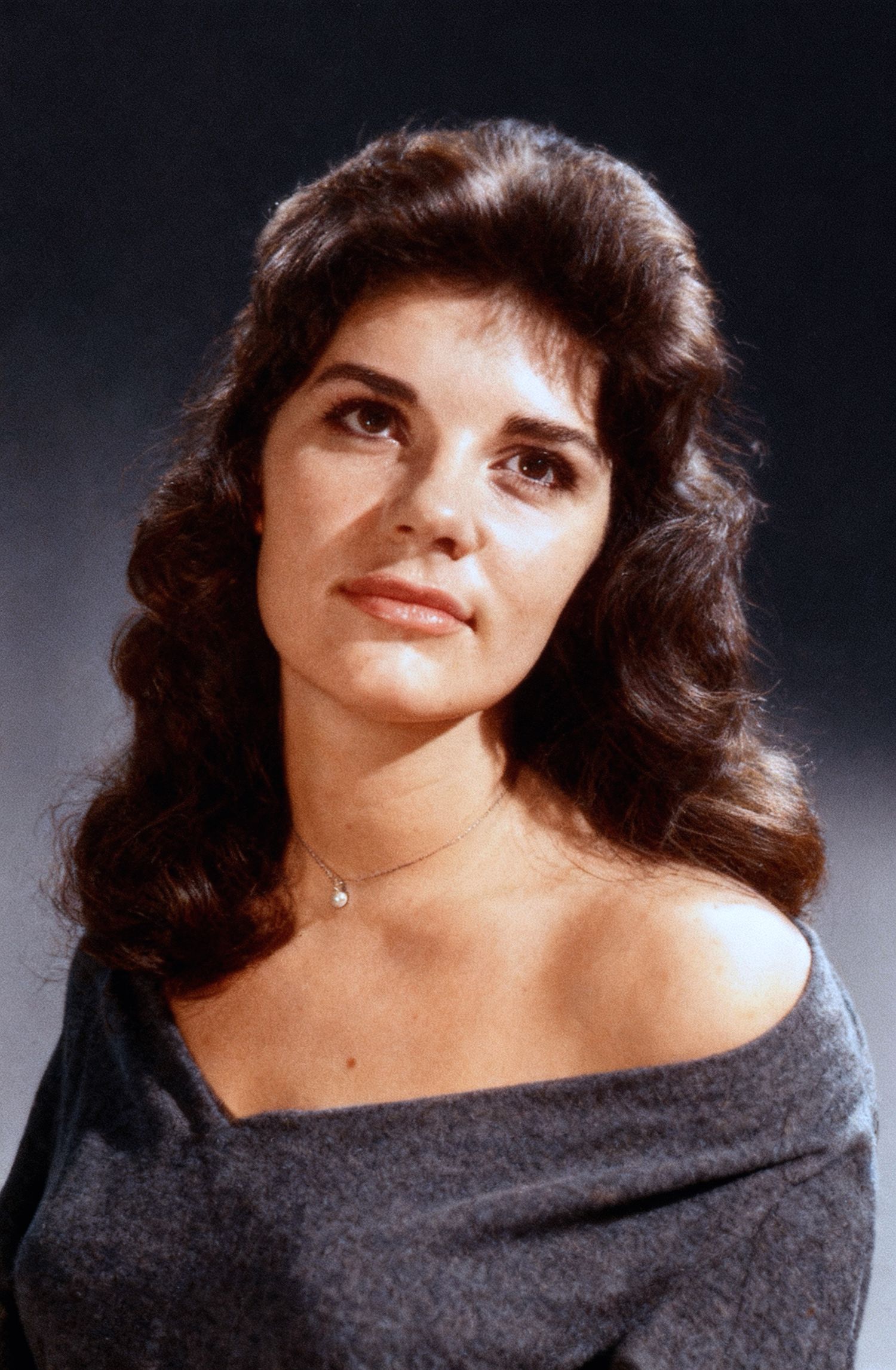 A series of glamour portraits showing a person with dark hair in a black off-shoulder top against a dark background.