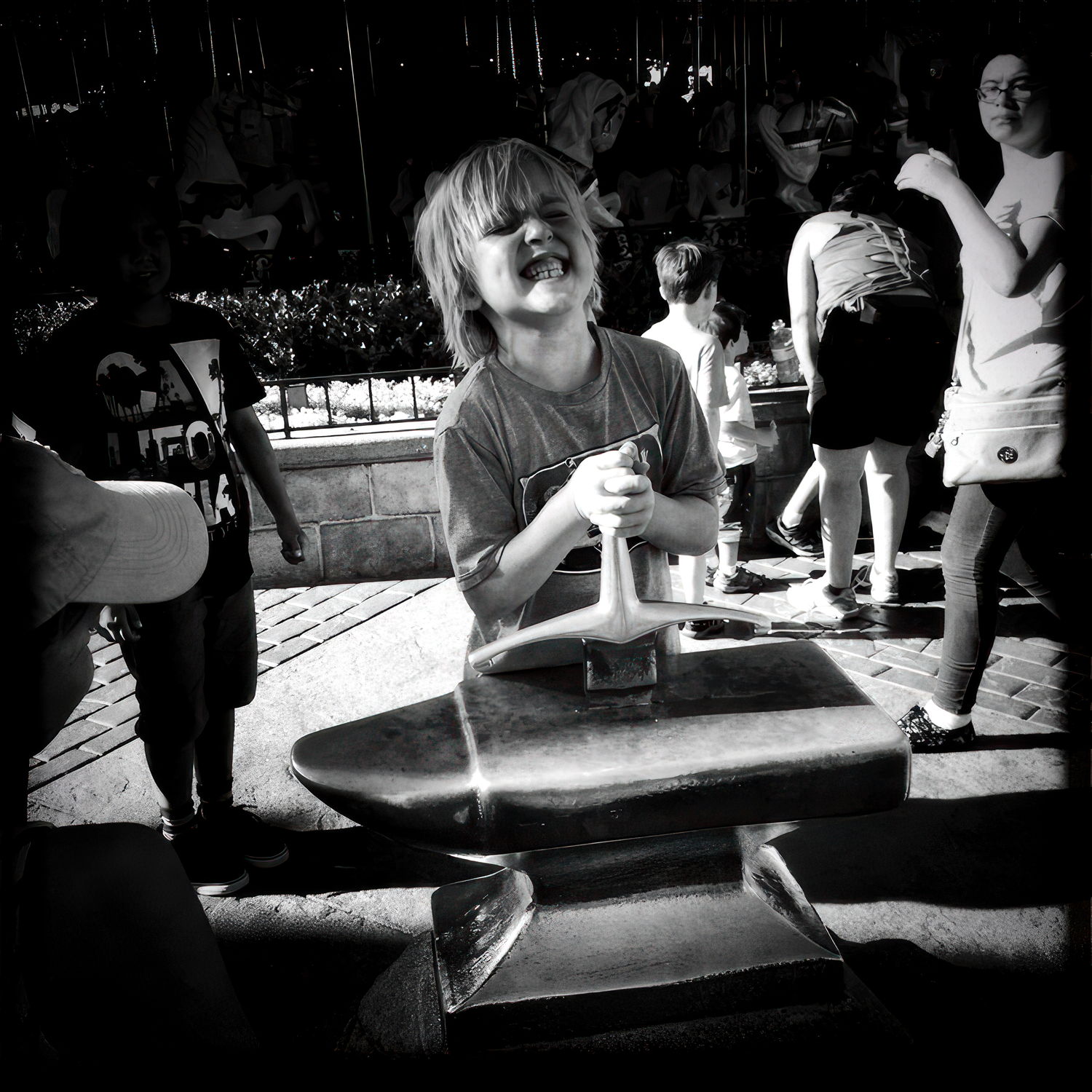 People enjoying drinks at a dimly lit bar counter with glassware and bottles visible in black and white photography.