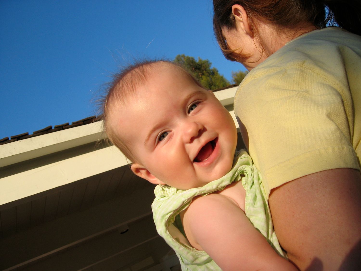 A series of candid laughing expressions captured in a sequence of photos.