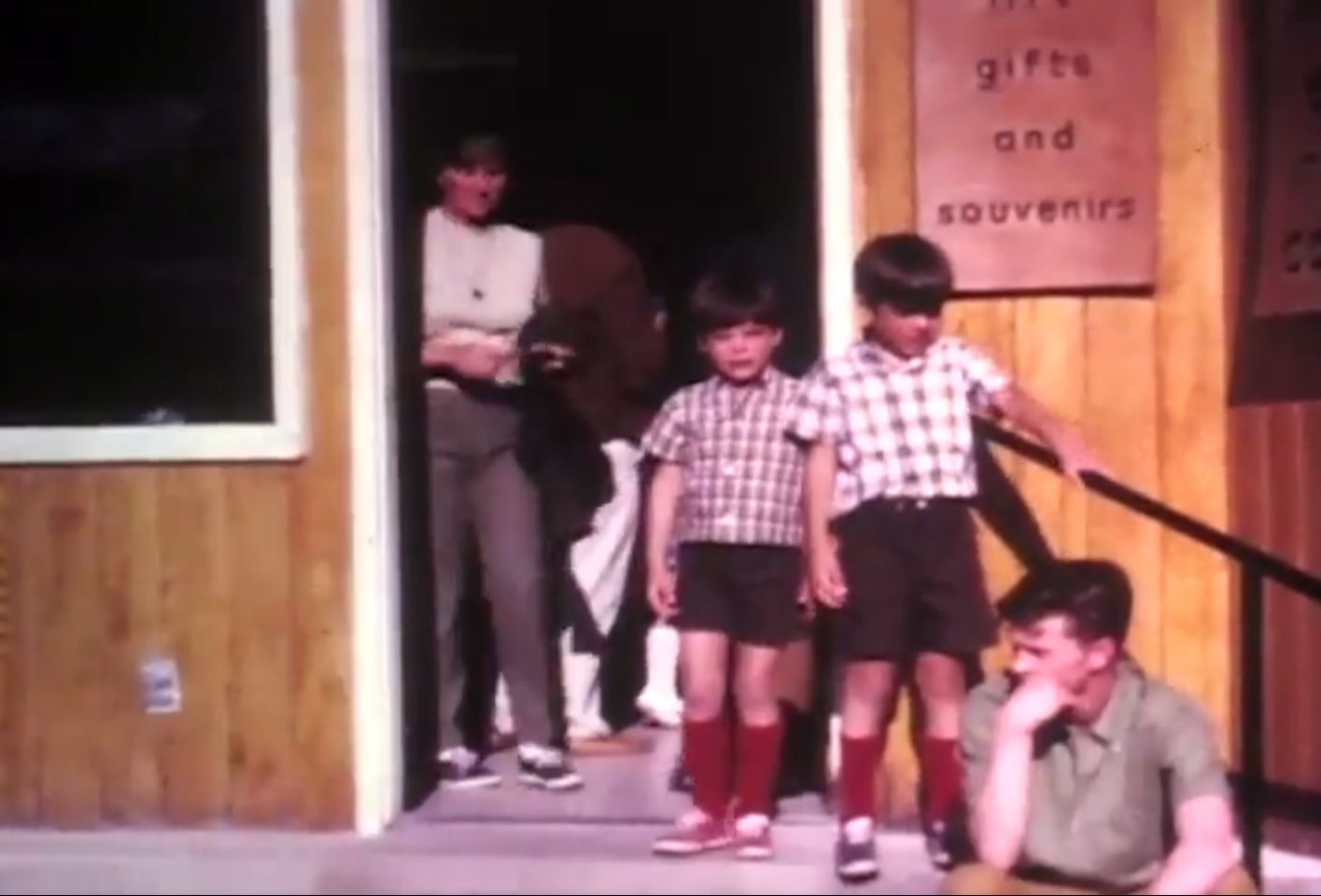 Vintage photograph of children gathered outside a gift shop entrance.