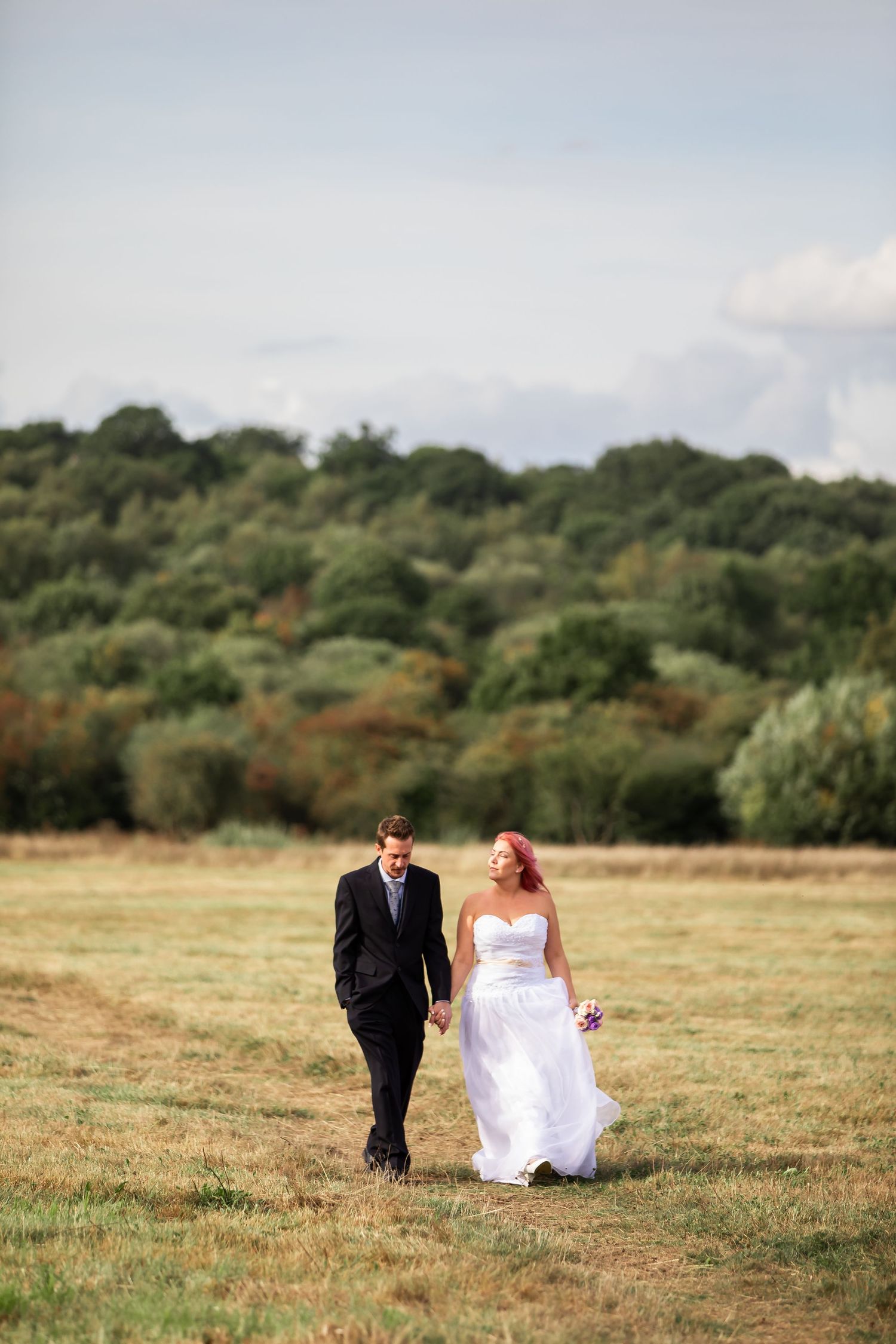 Bride and groom sharing private moment at sunset in Surrey countryside