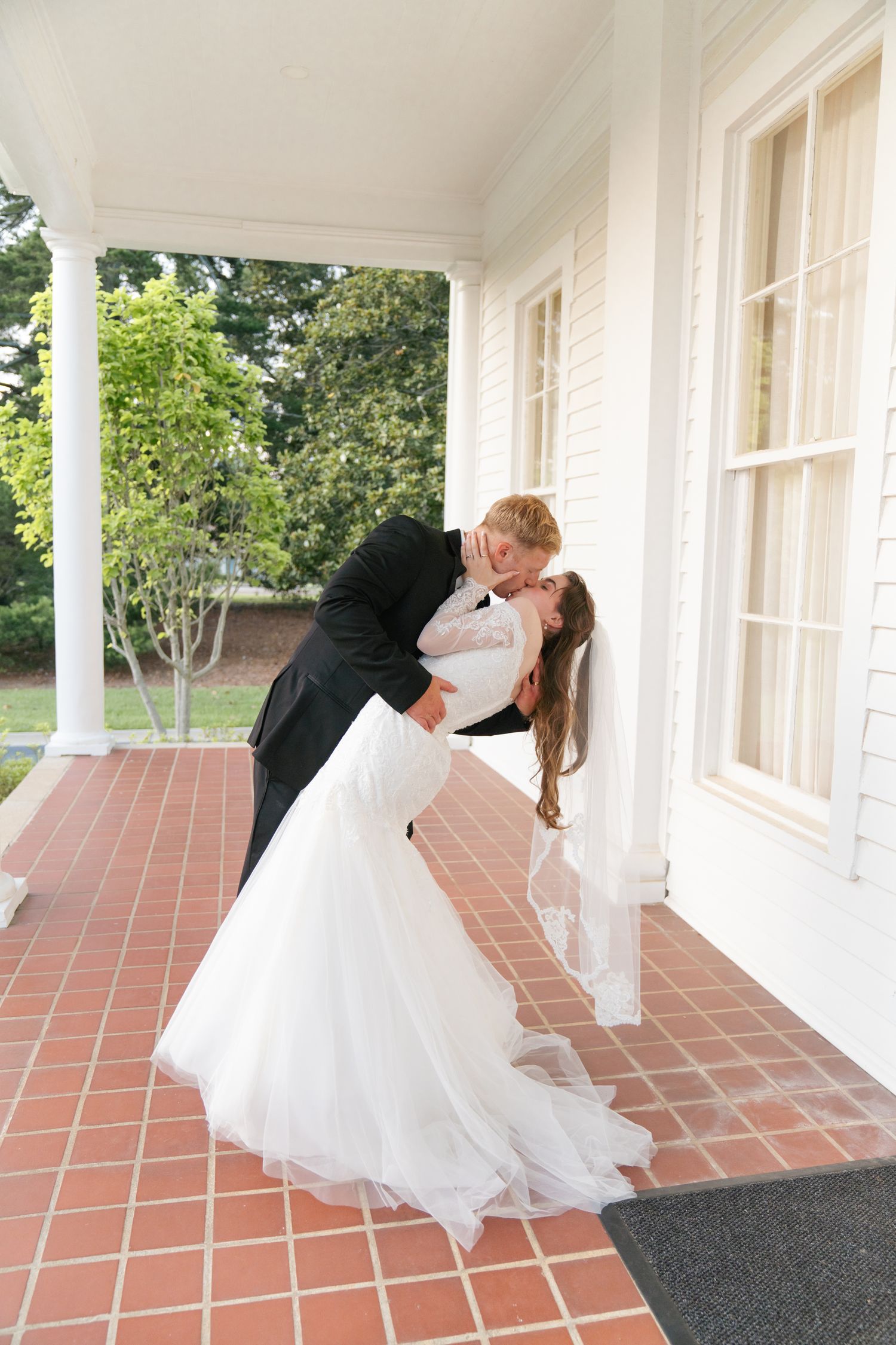 Romantic dancing sequence on a terracotta tiled porch shows flowing white wedding dress.