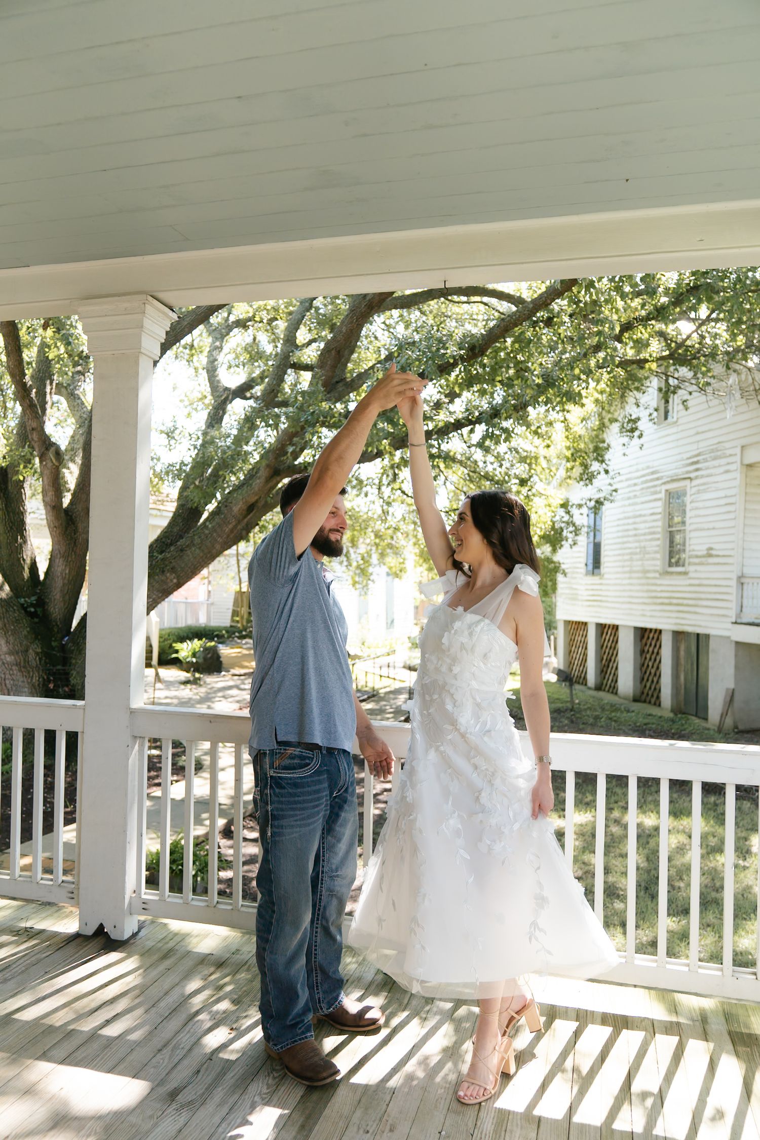 Playful dance sequence on a white porch with natural sunlight filtering through trees.