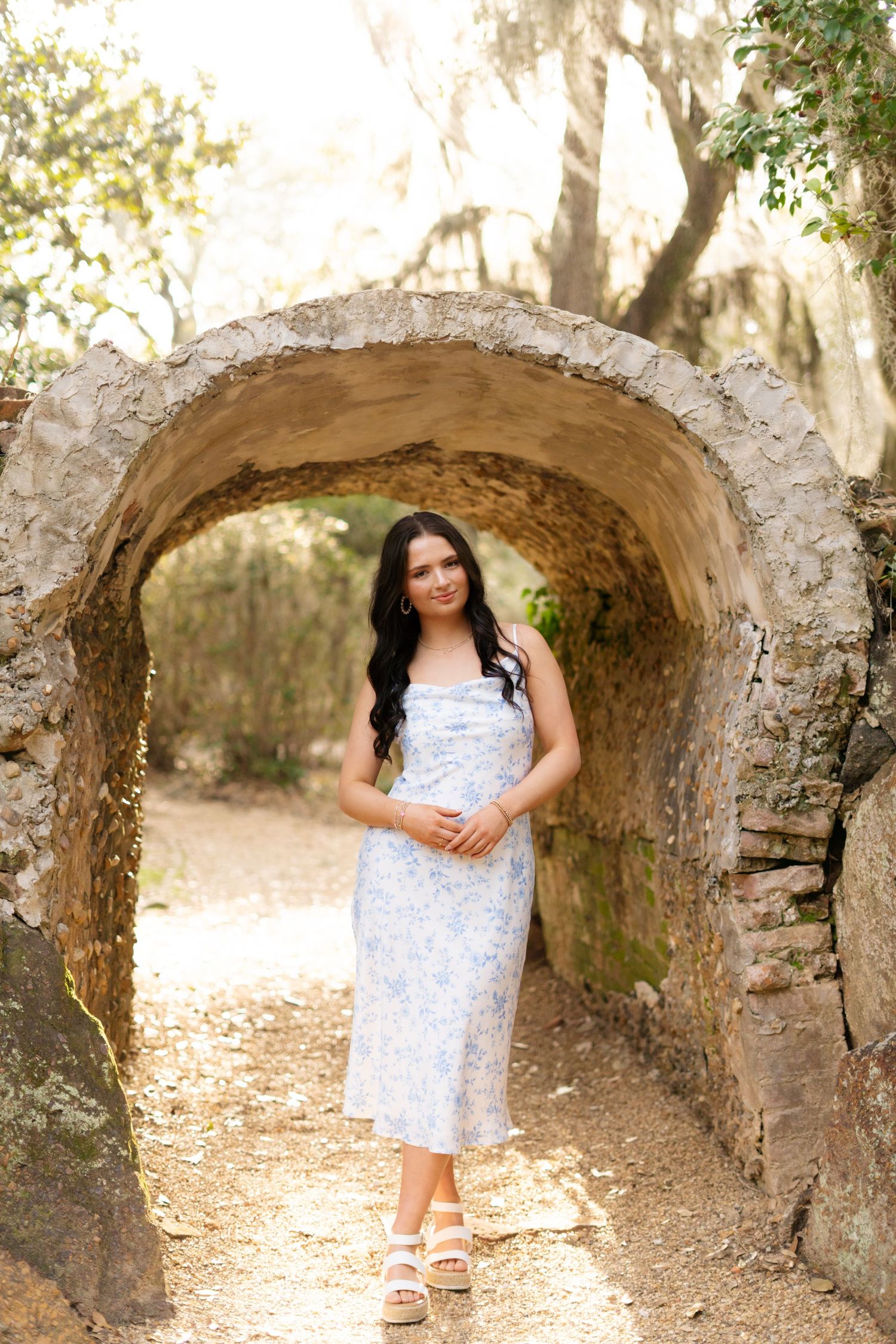 A collection of photos taken under a rustic stone archway in a natural outdoor setting.