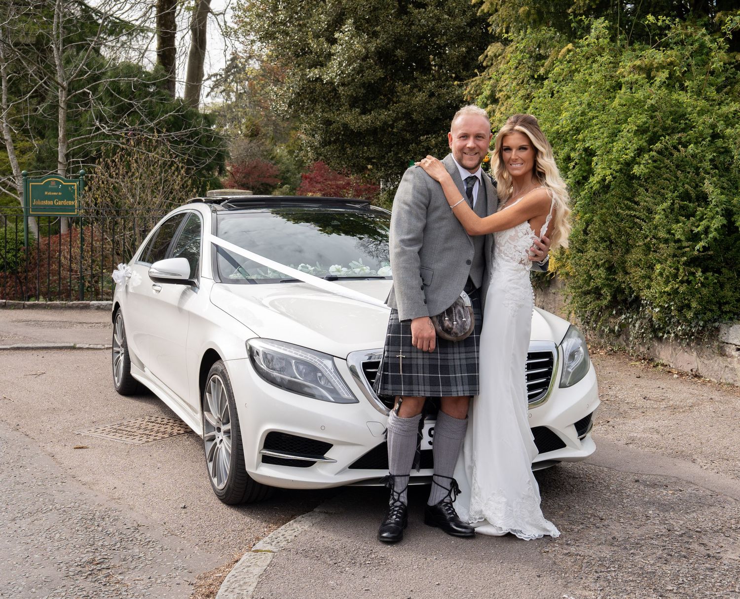 bride and groom stood in front of the wedding car at johnston gardens Aberdeen.