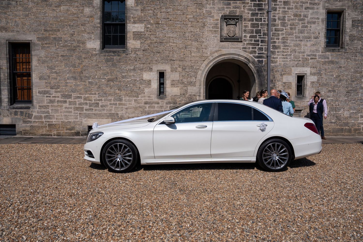 white mercedes s class 350 dl wedding car at a castle in Edinburgh