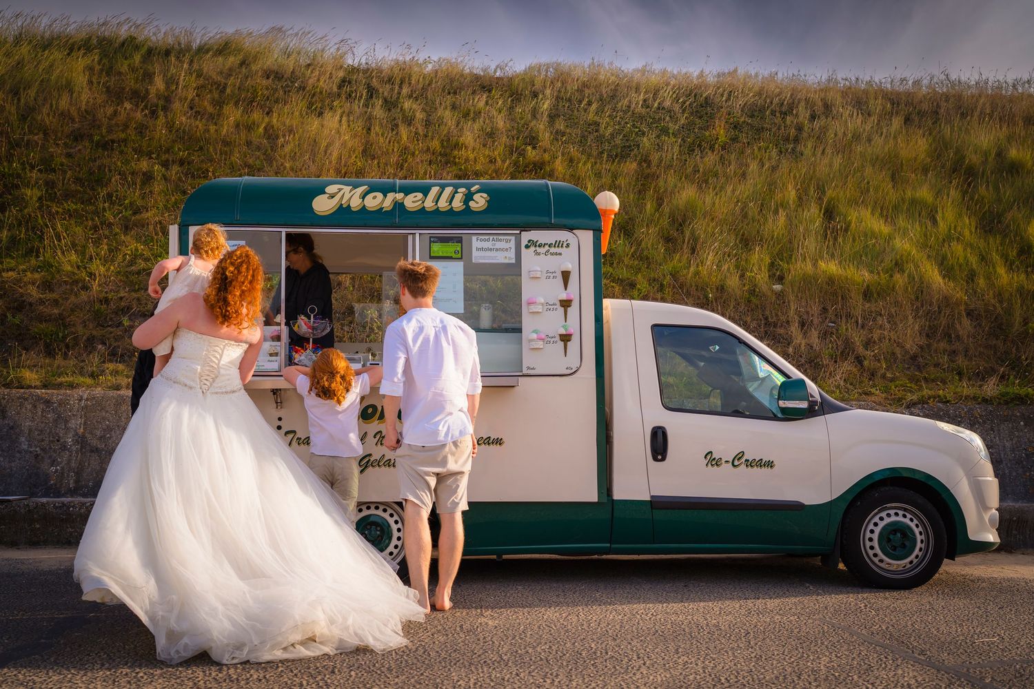 A Family dressed in Wedding clothes getting an ice cream on Westbrook Beach for a wreck the dress family photo session with shorely a memory