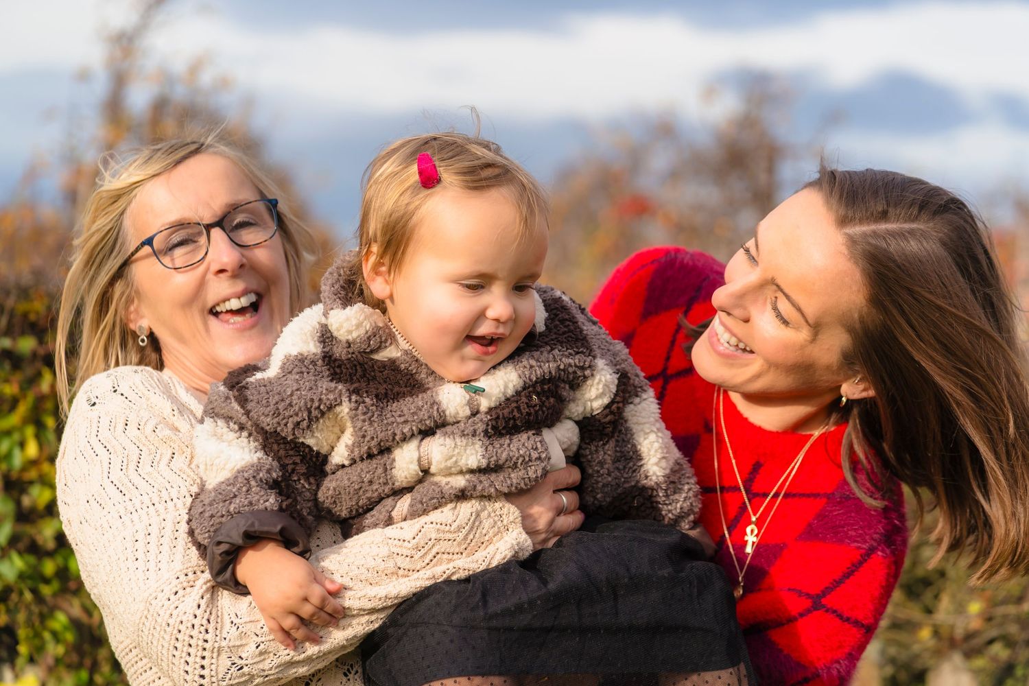 Three generations together in the orchard, spinning and laughing together.