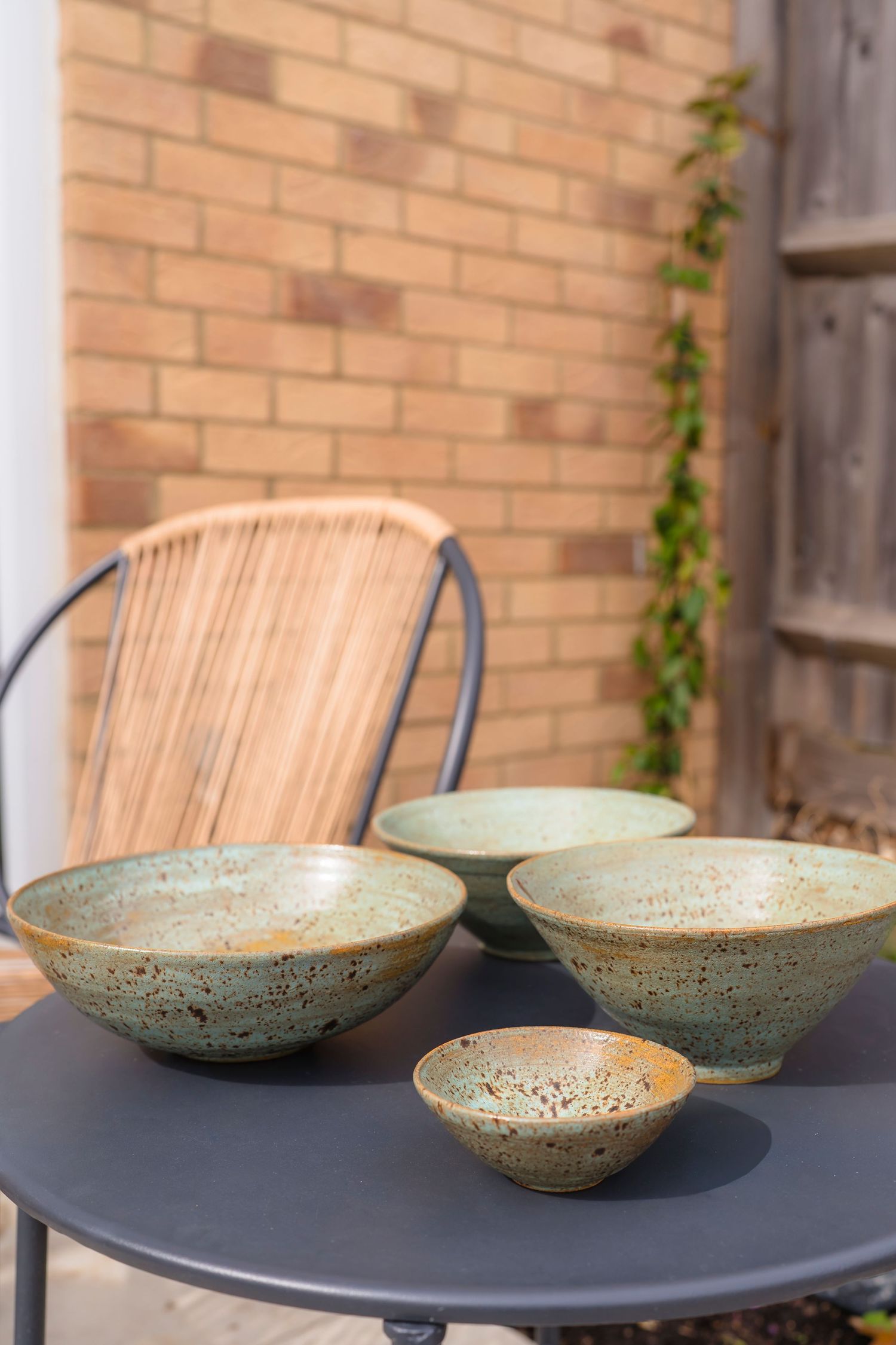 Beautiful hand made speckle bowls a beautiful garden set up to show how they would look on your table. lifestyle session