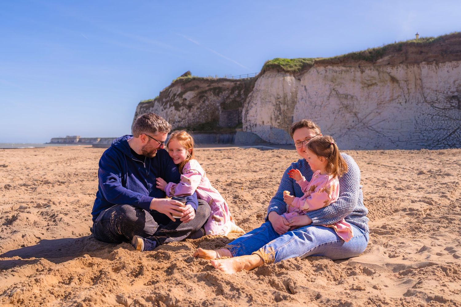 A family of 4 on beautiful sandy Thanet beach with sunlight and wind for the perfect candid moments with shorely a memory photography