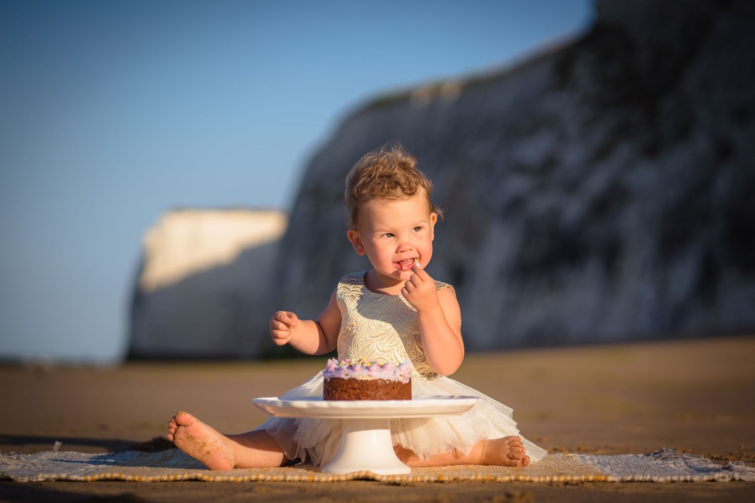 Botany Bay cliffs as the background to this little girls first cake smash. Cake on the beach with beautiful golden light.