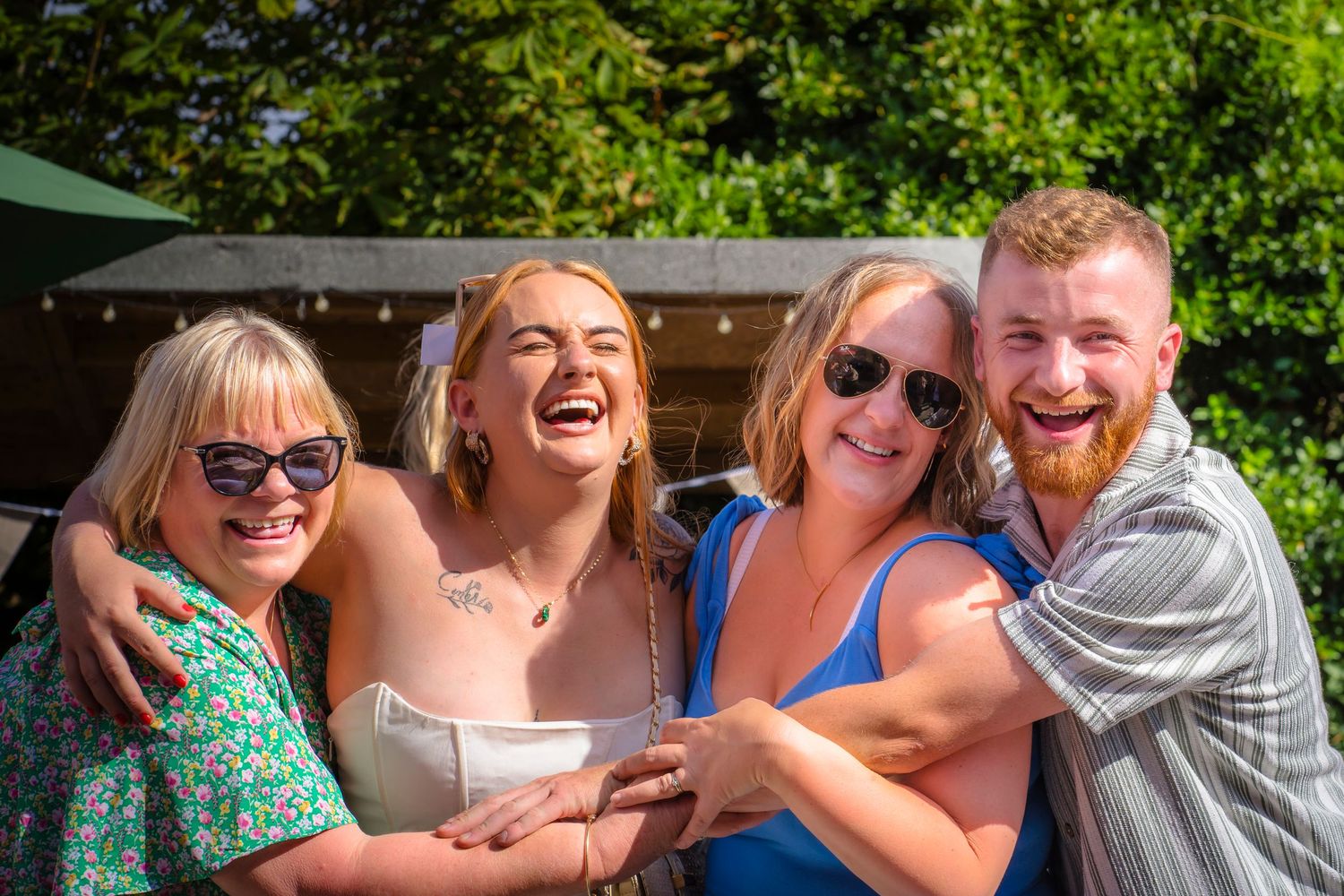 Family hugs at a celebration gathering, candid and unposed, real emotions from shorely a memory photography.