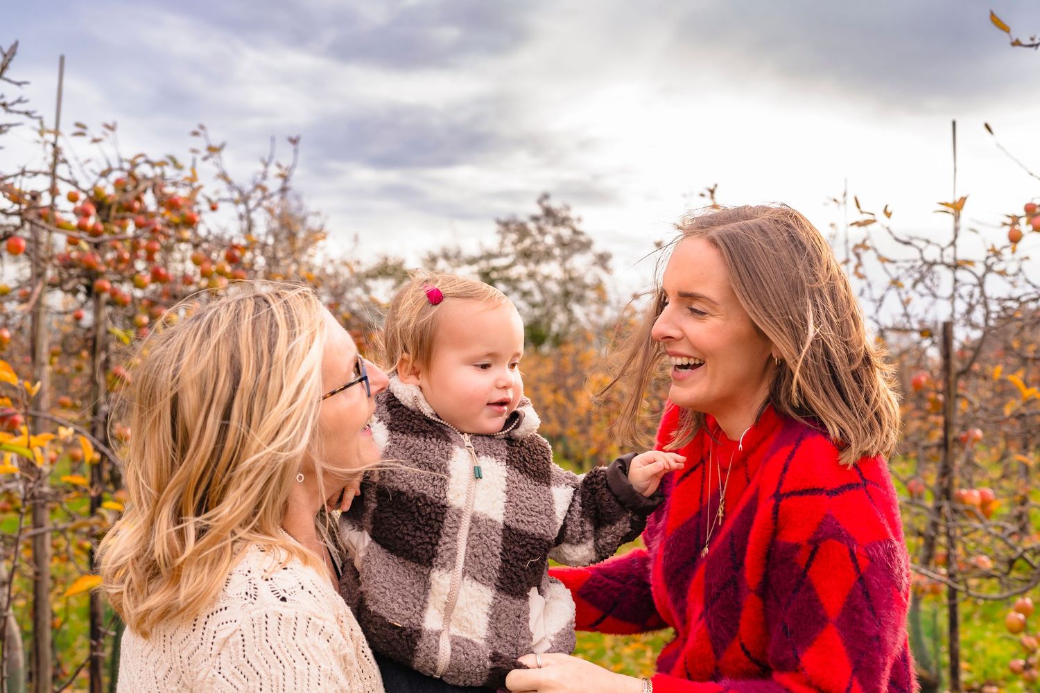 Three generations together in the orchard, spinning and laughing together.