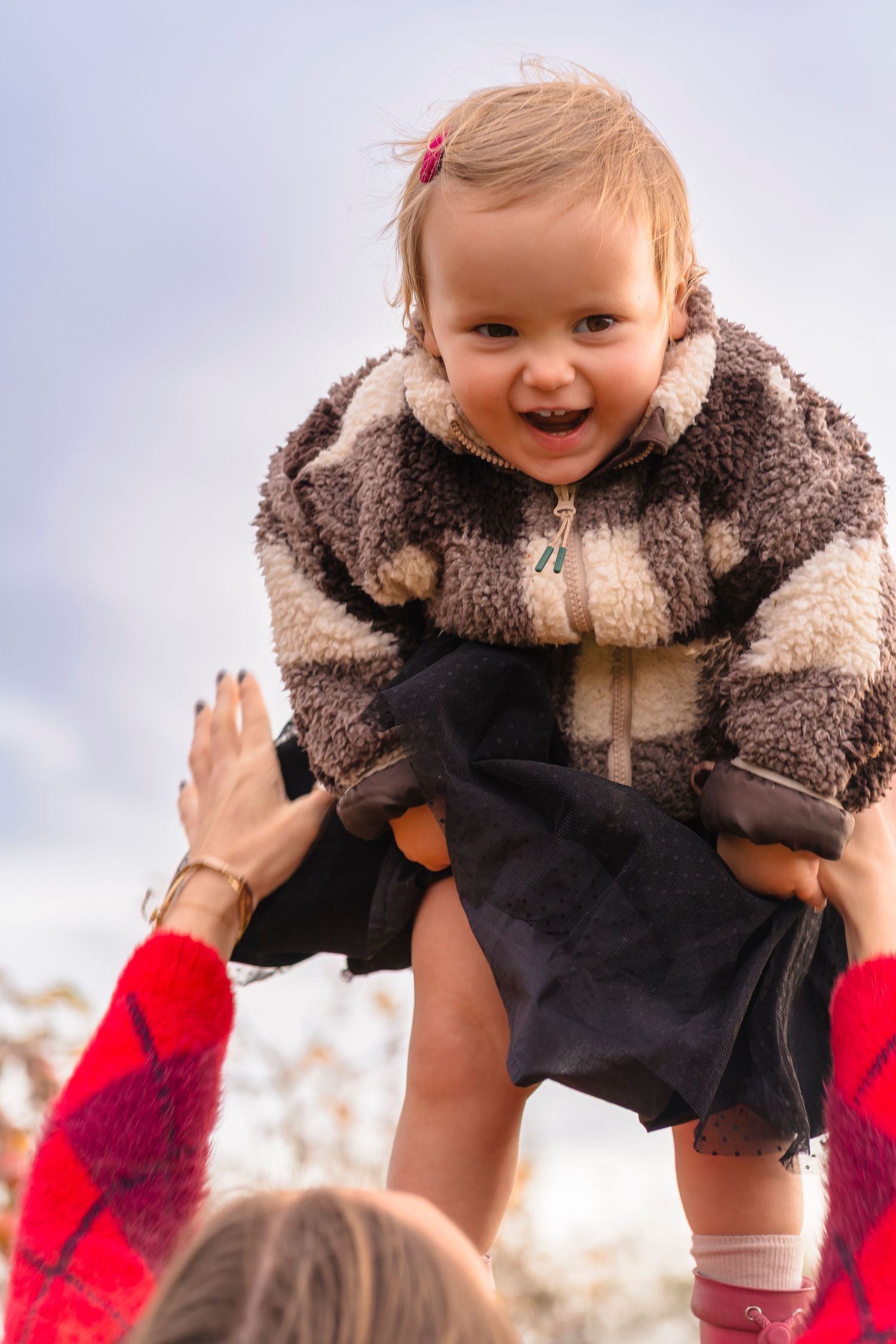 mother holding her daughter up in the air to get those genuine smiles that can't be forced.