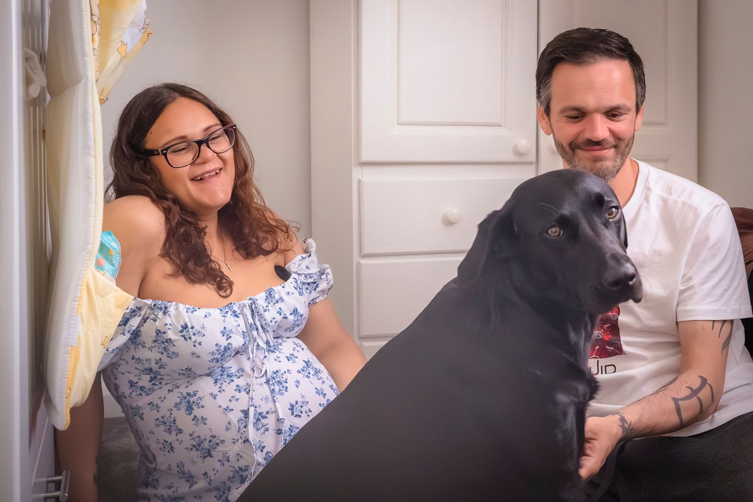 Expectant mother and father with their black Labrador at a maternity in home photo session with shorely a memory photography, Kent.