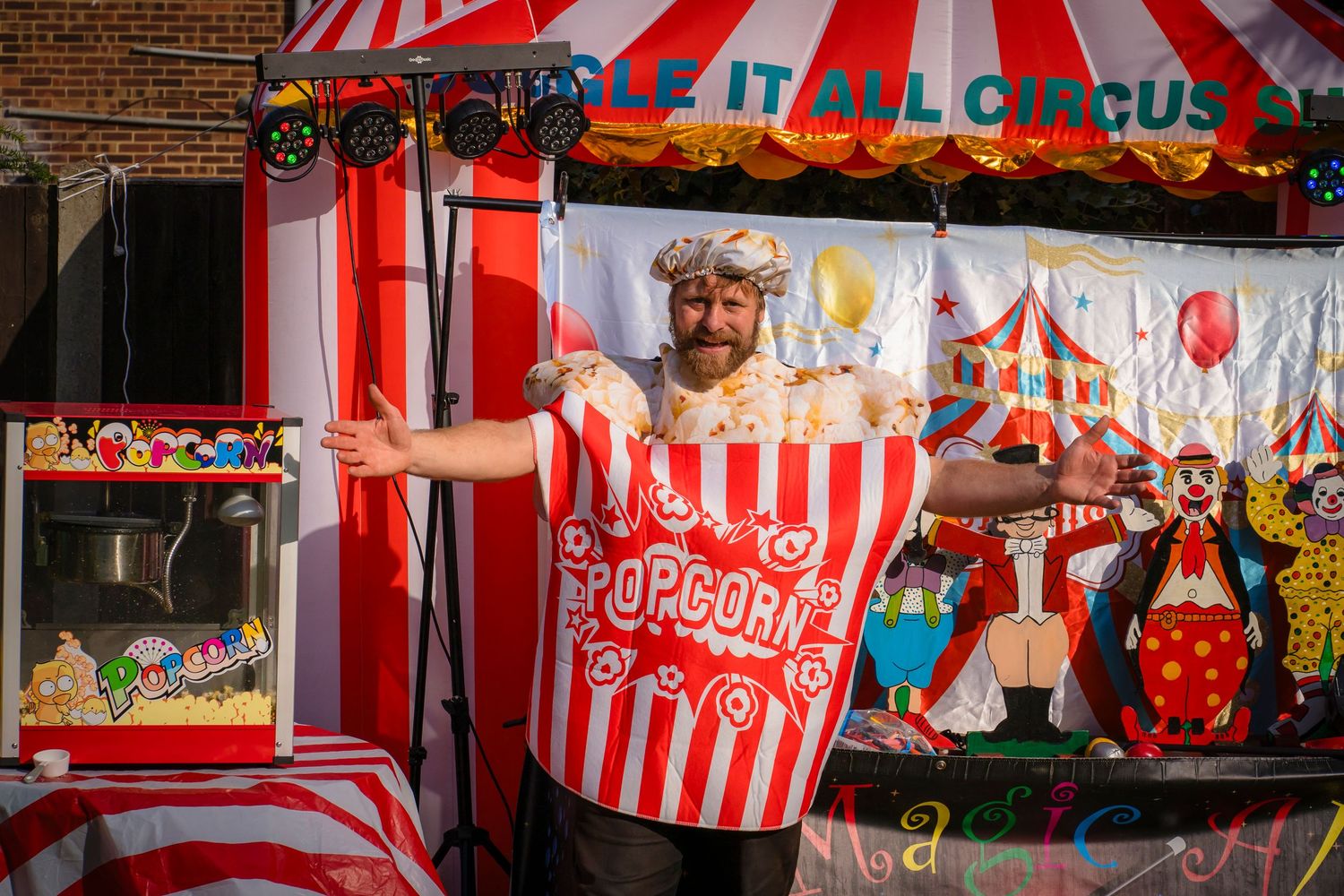 Party entertainer giving out popcorn to a family loving the entertainment. smiles and laughing showing the fun from the party.