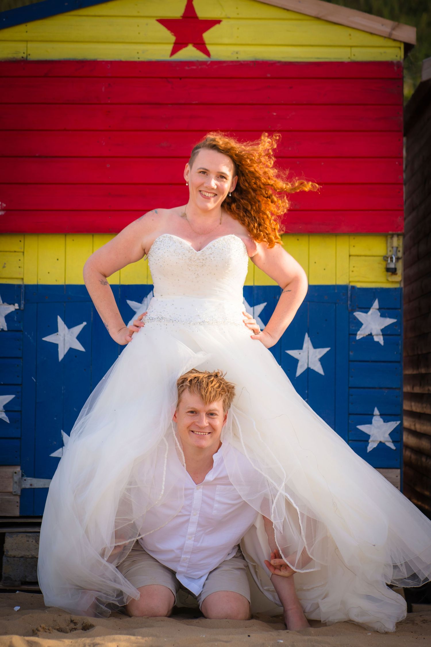 Wonder woman pose with a husband and wife, strong and powerful with wind blown hair, taken on Westbrook beach in Margate.