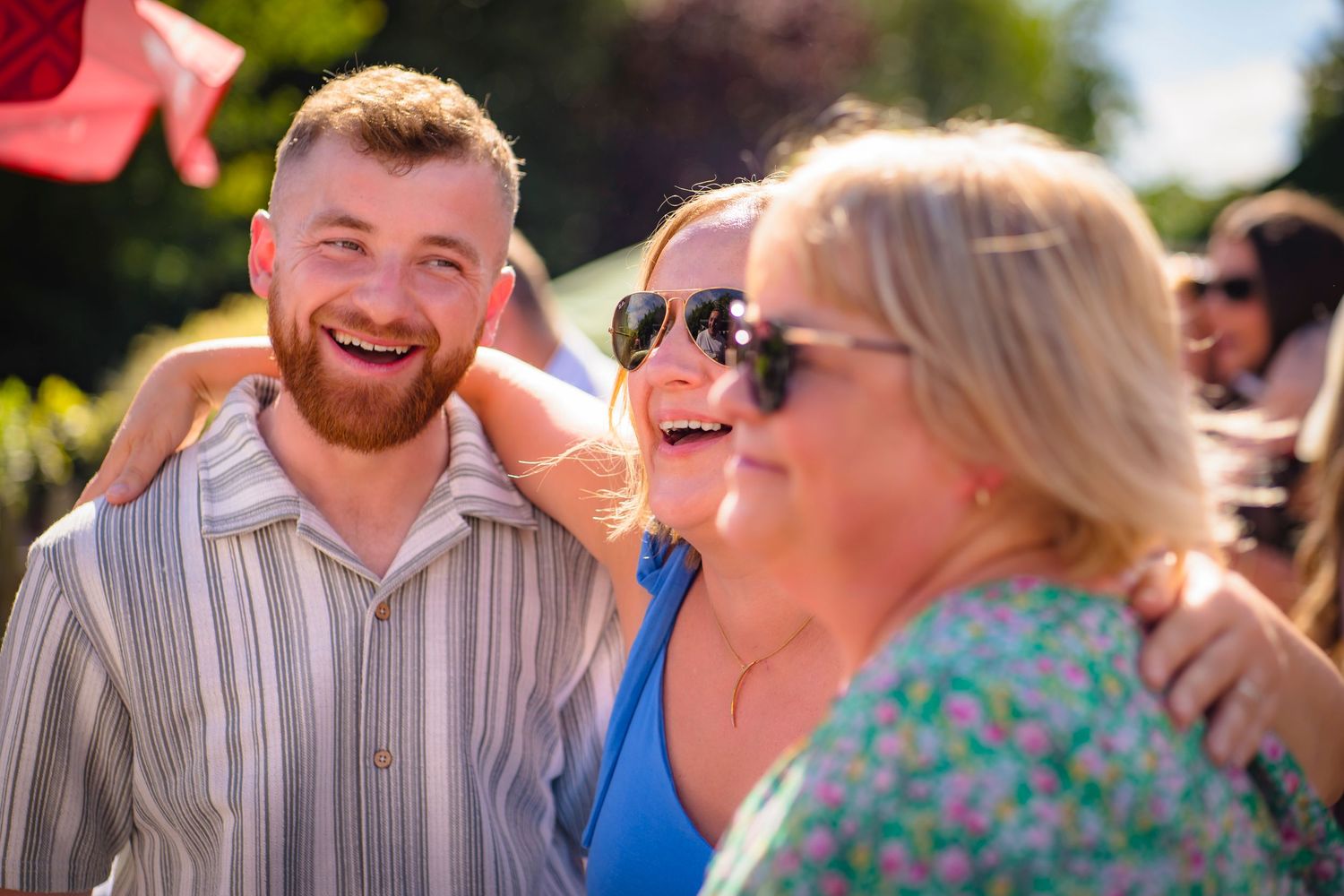 Family hugs at a celebration gathering, candid and unposed, real emotions from shorely a memory photography.