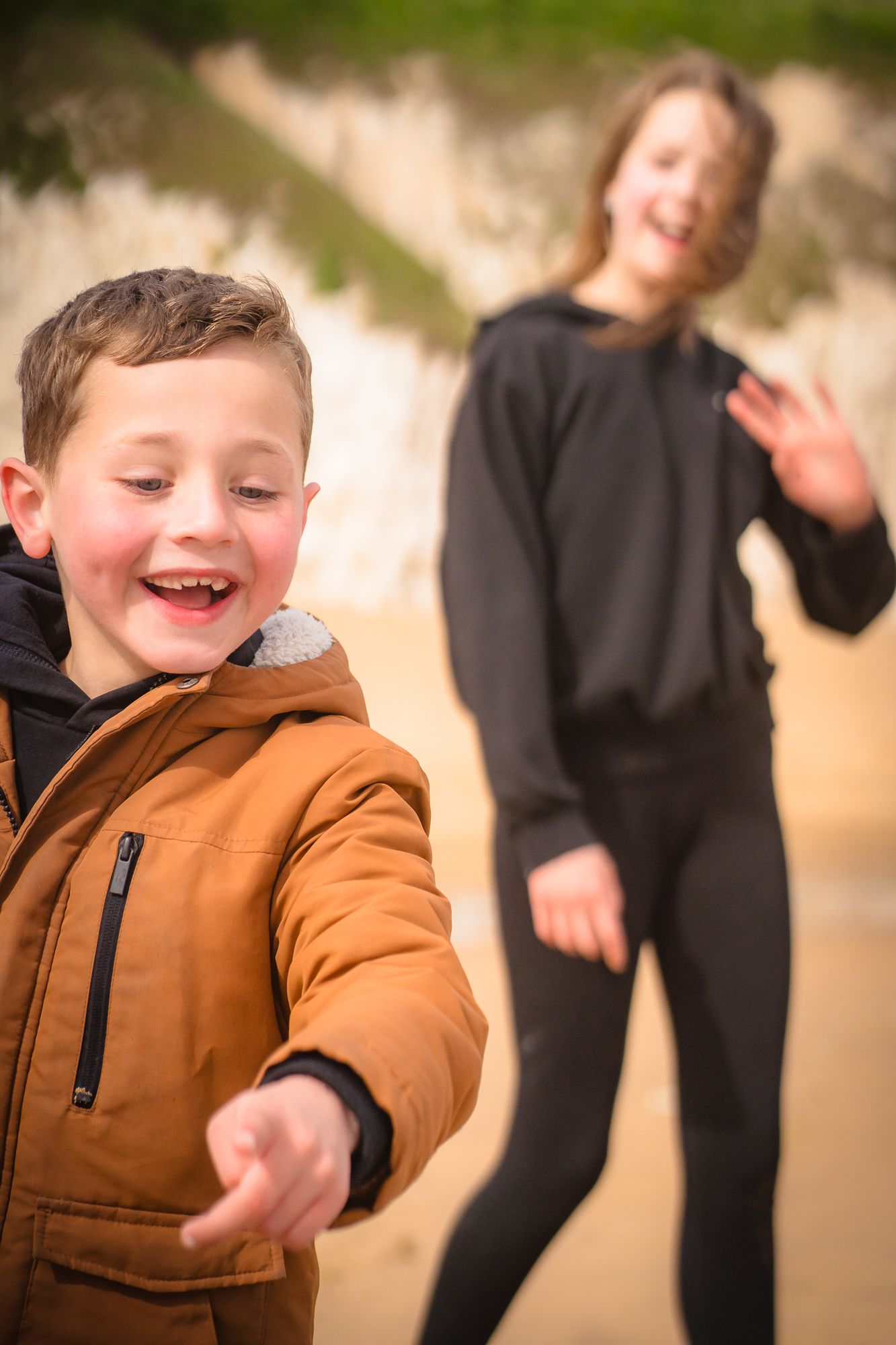 Siblings laughing whilst on the sand on a family photo session at Botany Bay, Margate with Shorely a Memory Photography, Kent.