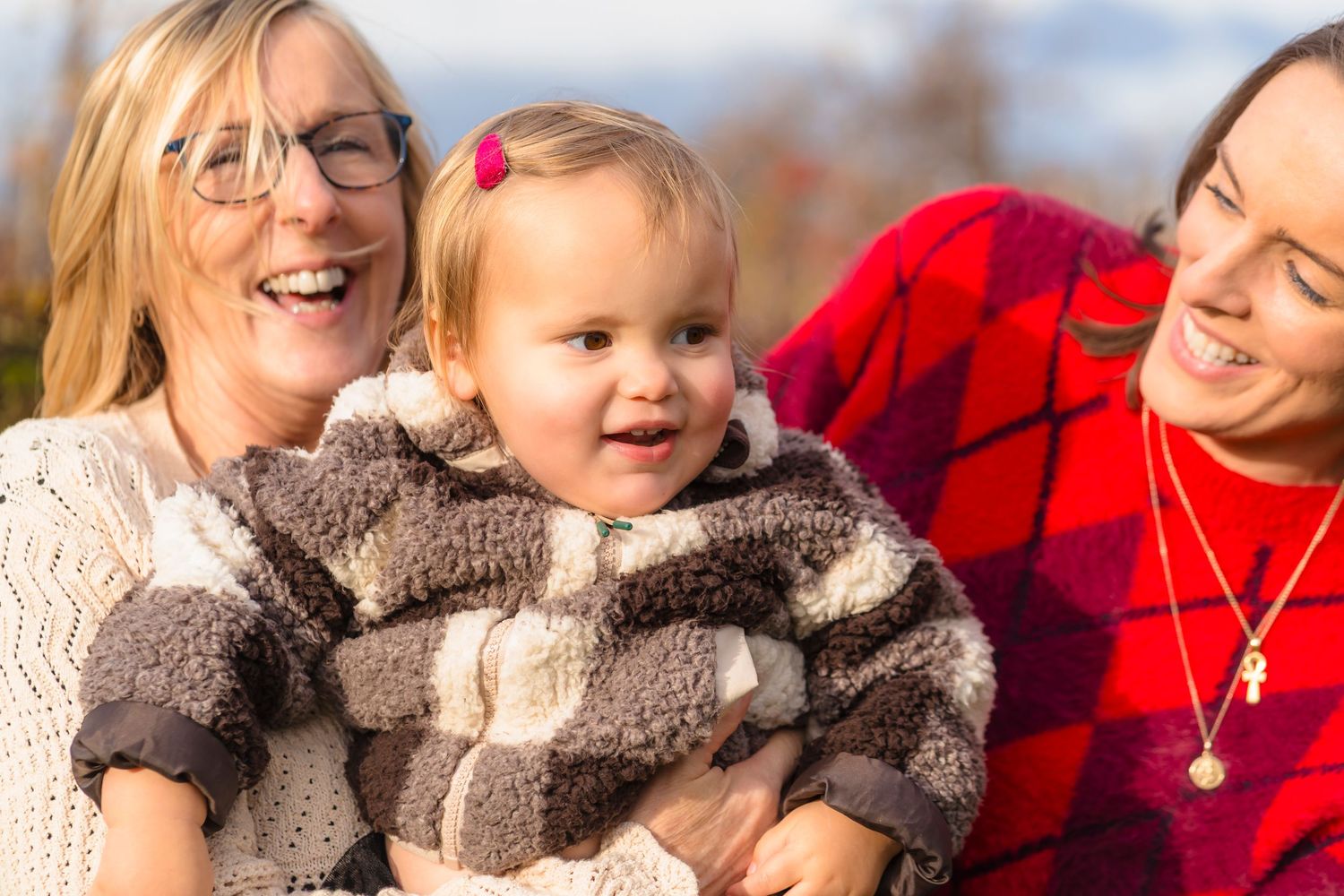 Three generations together in the orchard, spinning and laughing together.