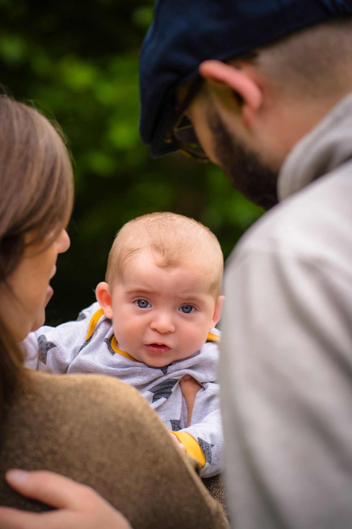 Beautiful family portrait of a baby looking over his parents shoulders. Family photo session in Broadstairs park with shorely a memory photo