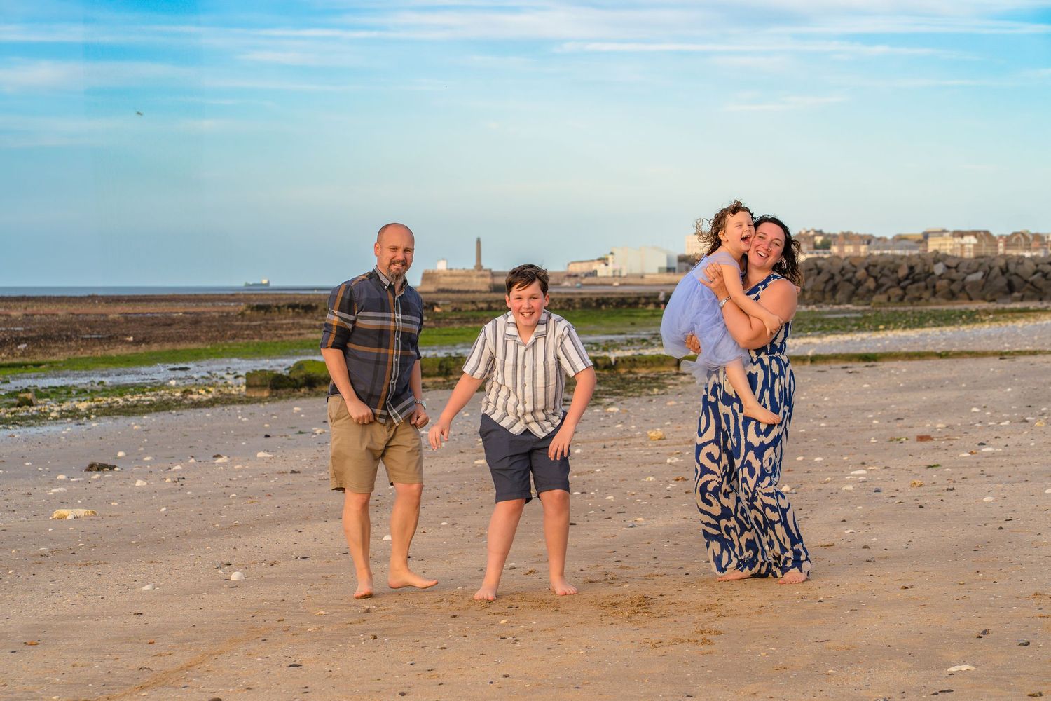 Family of 4 dancing on Westbrook beach at a candid and fun family photo session with Shorely a Memory in Margate Kent.