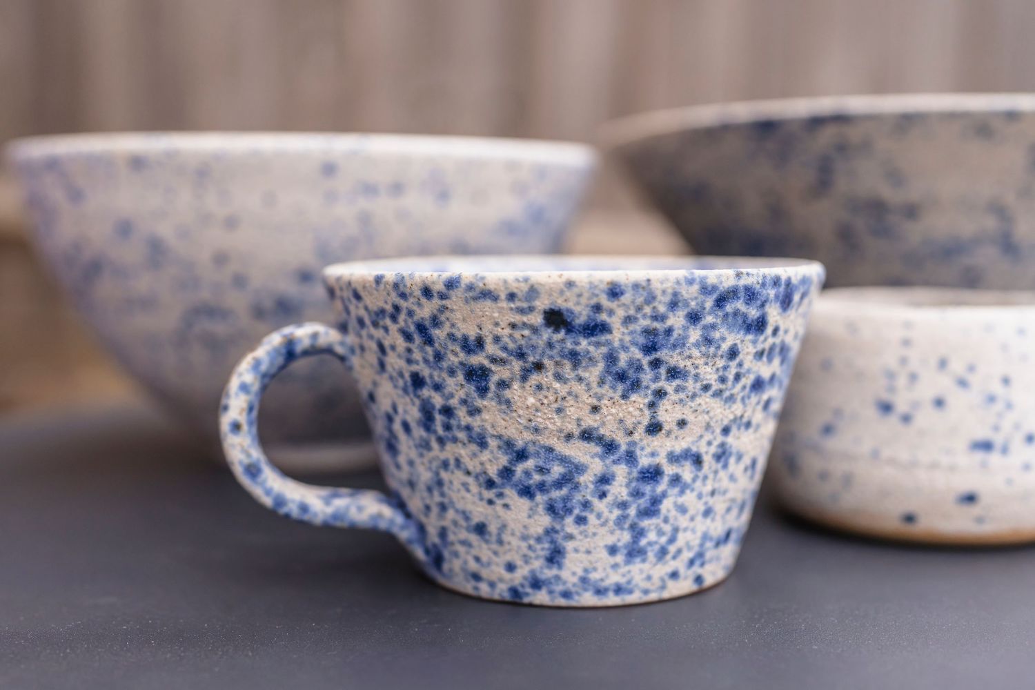 blue and white speckles cup and bowls at a lifestyle branding session with a ceramicist.