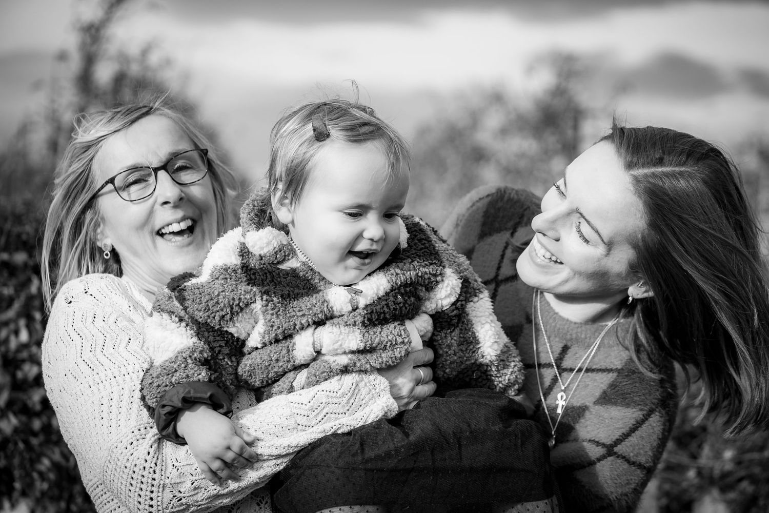 Three generations together in the orchard, spinning and laughing together.