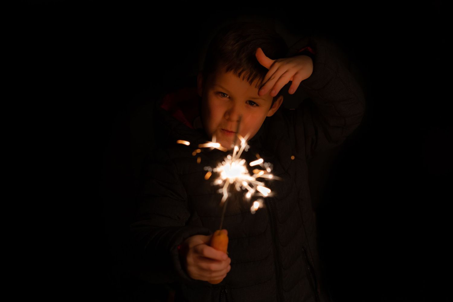 Magic and sparkle, a young magician holding a sparkler and making magic, capturing moments with shorely a memory photography, Kent.