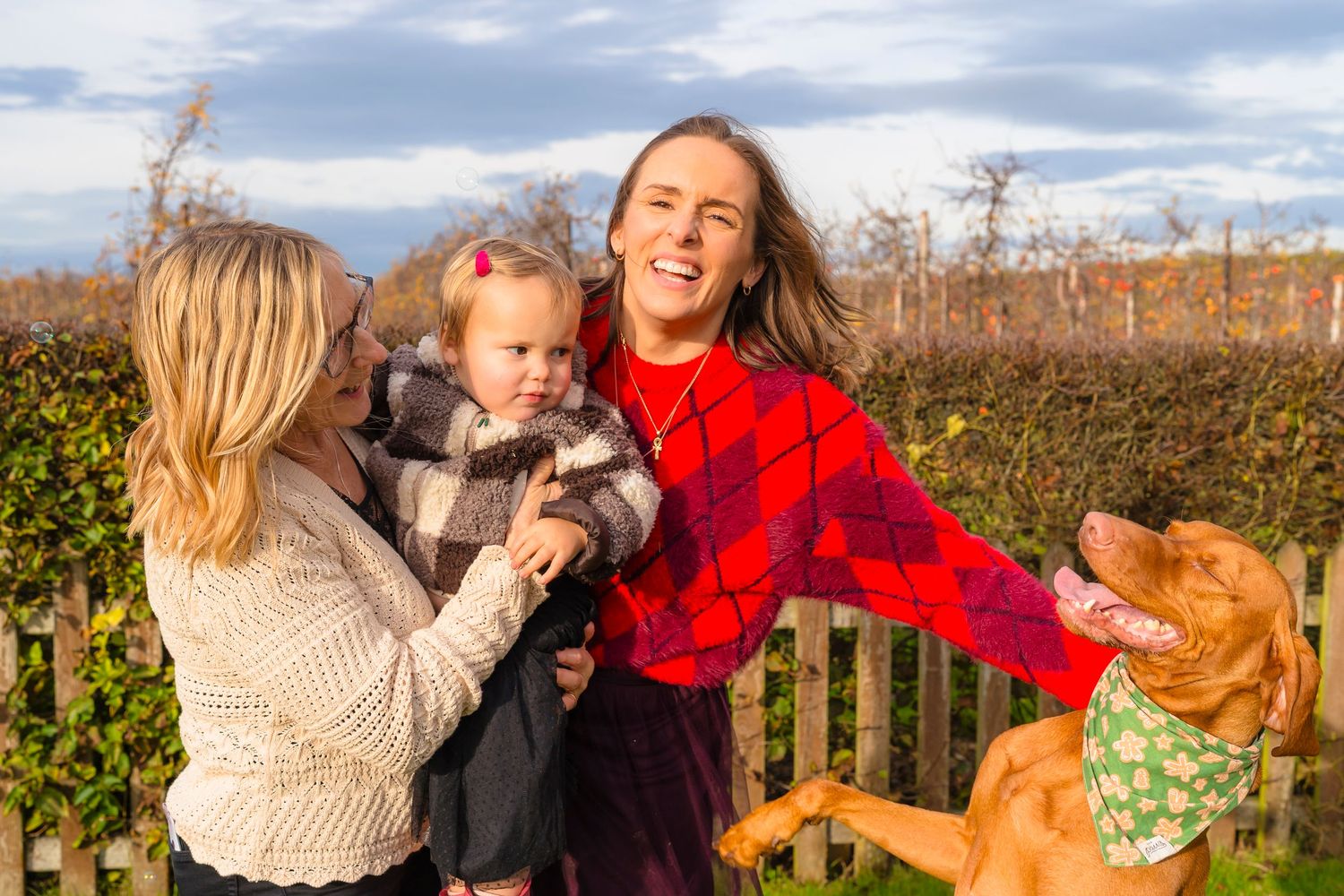 Three generations together in the orchard, spinning and laughing together.