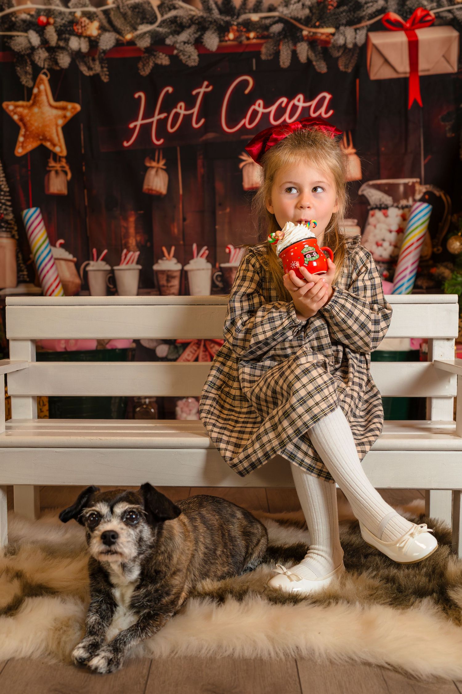 Cool young girl at her Cosy Cocoa mini session, drinking cocoa on a white bench with her little dog next to her. Shorely a Memory Margate.