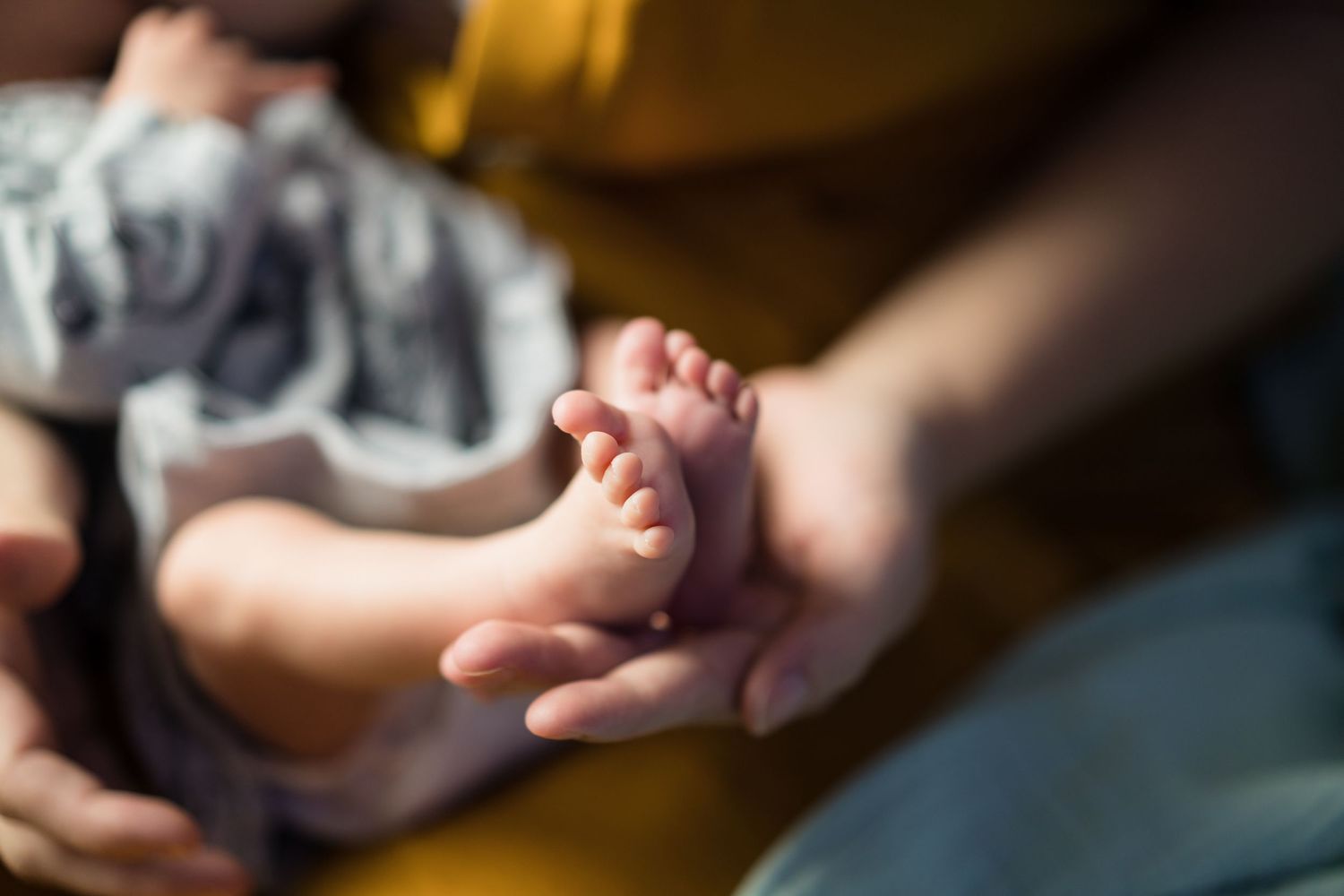 Baby feel in the palm of a hand, delicate and meaningful details from an in home family photo session with shorely a memory photography.