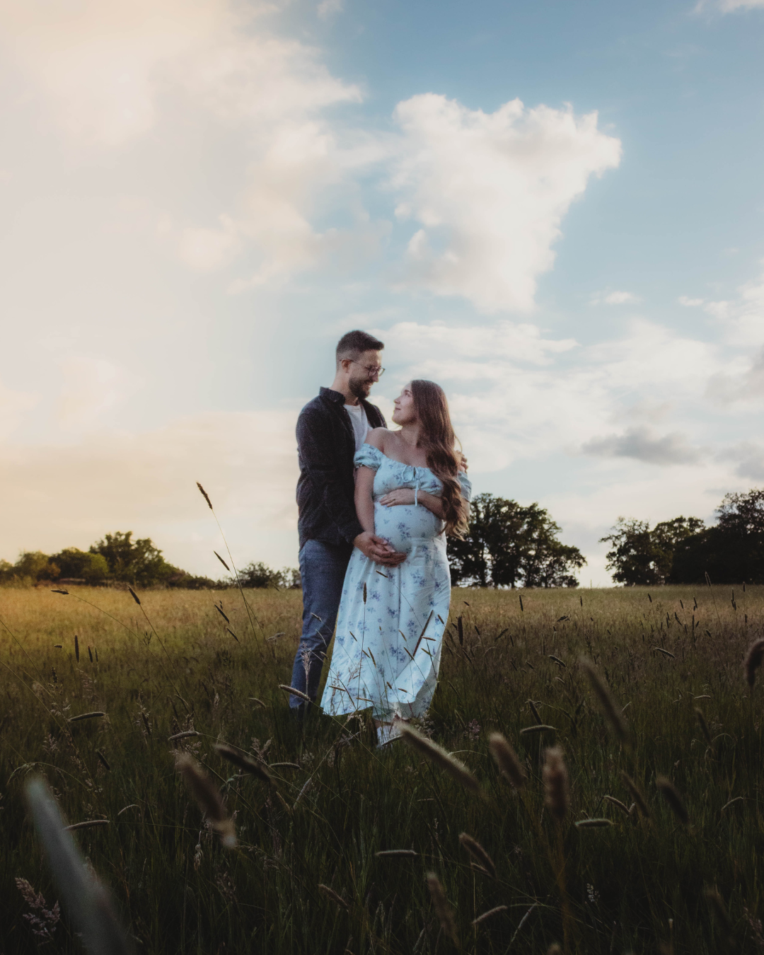 Maternity photoshoot in Surrey countryside, gentle connection between mum-to-be and partner