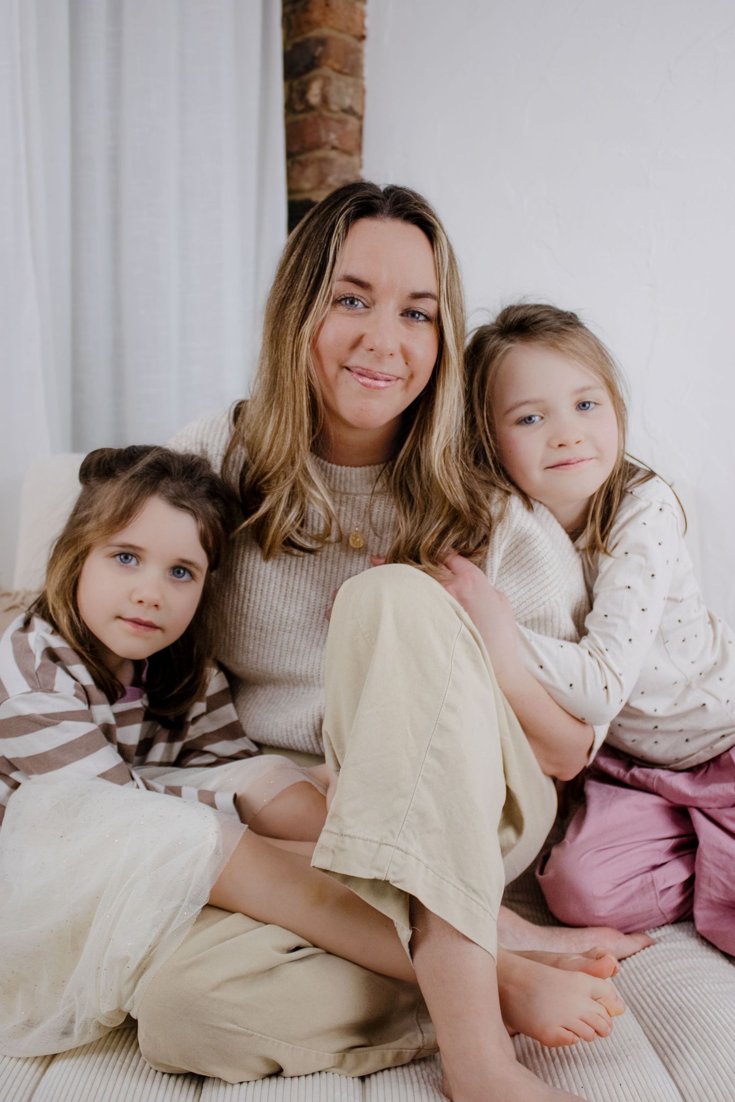 A series of tender moments captured between a parent and child sitting together in soft, neutral tones.