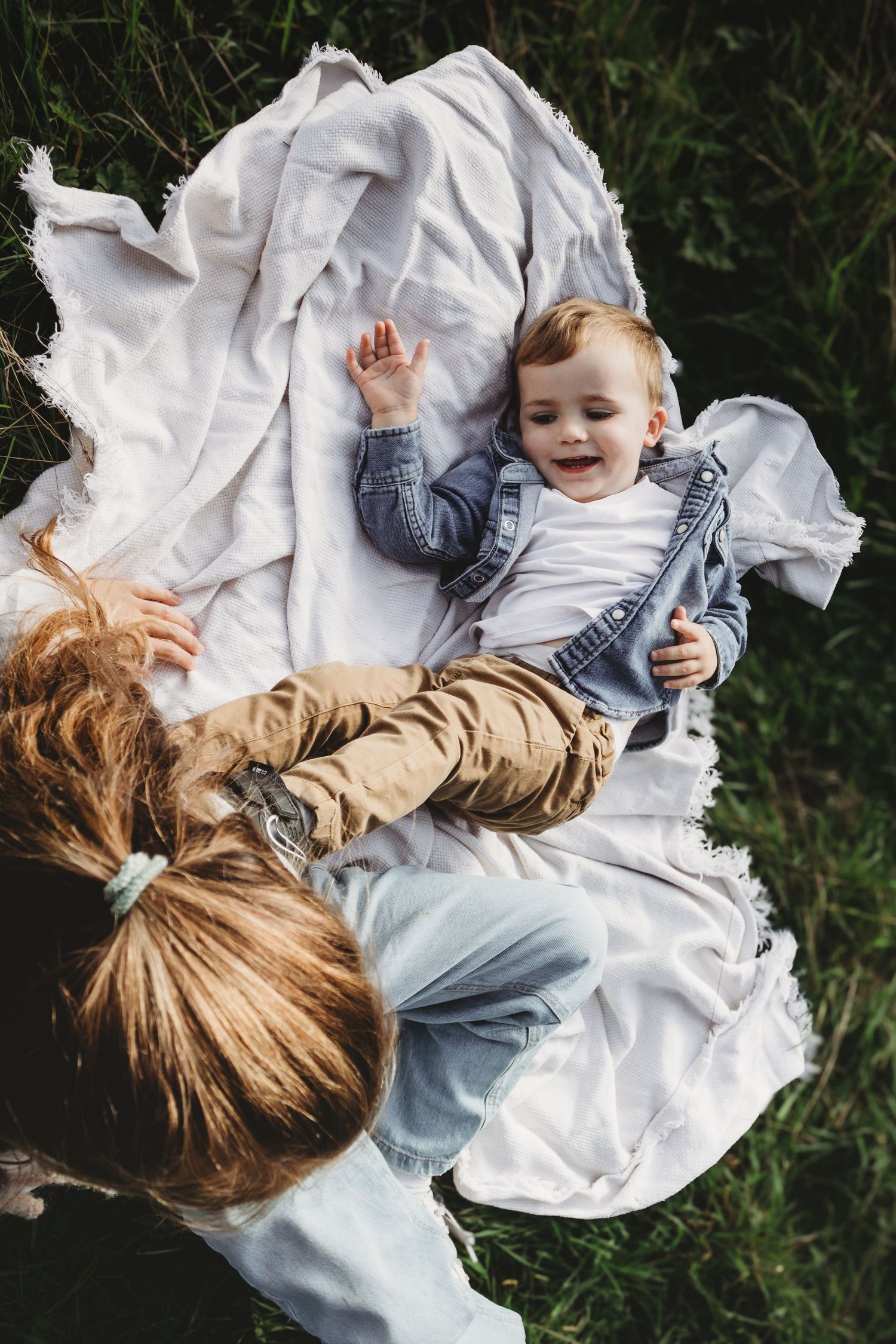 Family photography session in Surrey countryside – joyful candid family moment captured at sunset