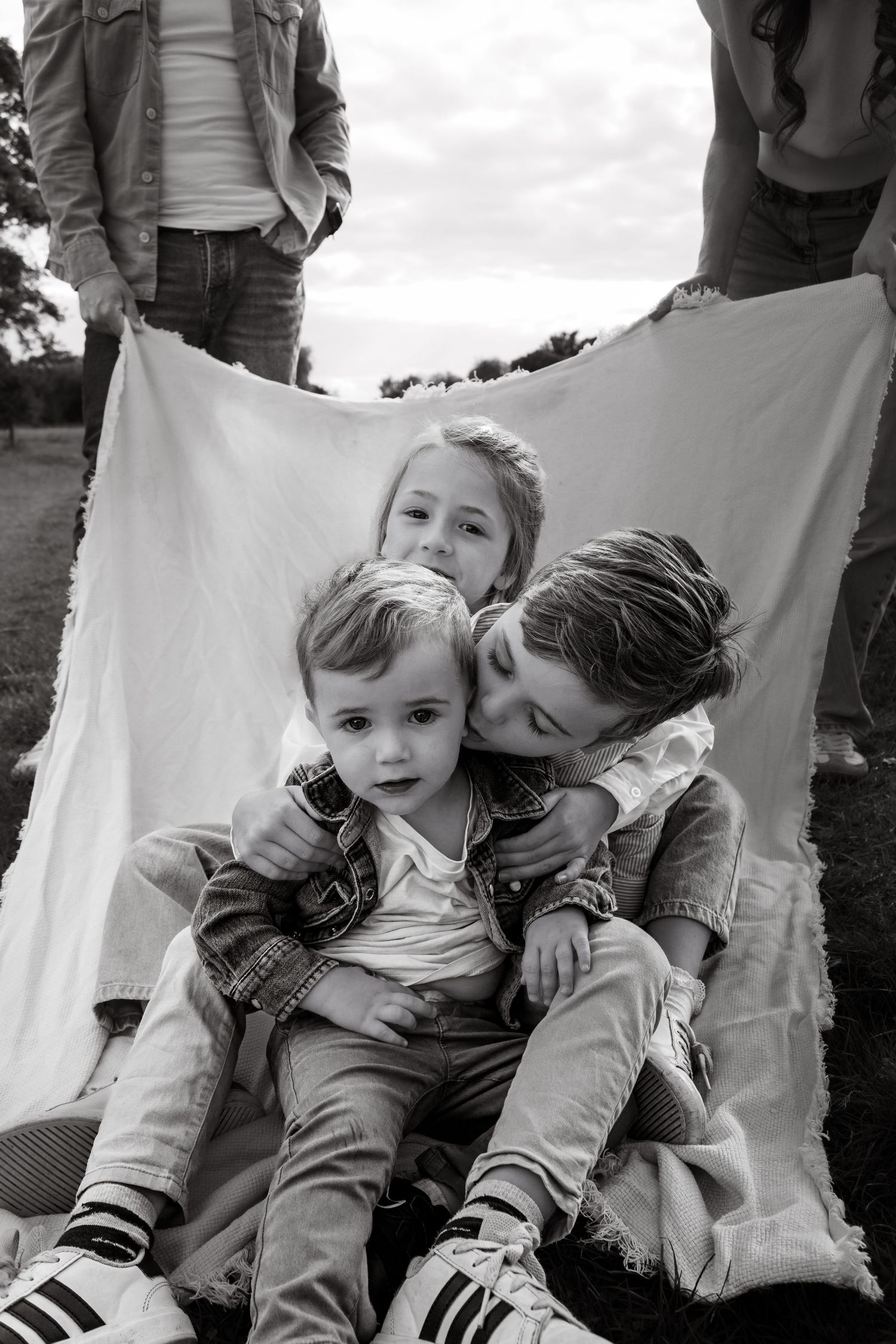 Family photography session in Surrey countryside – joyful candid family moment captured at sunset