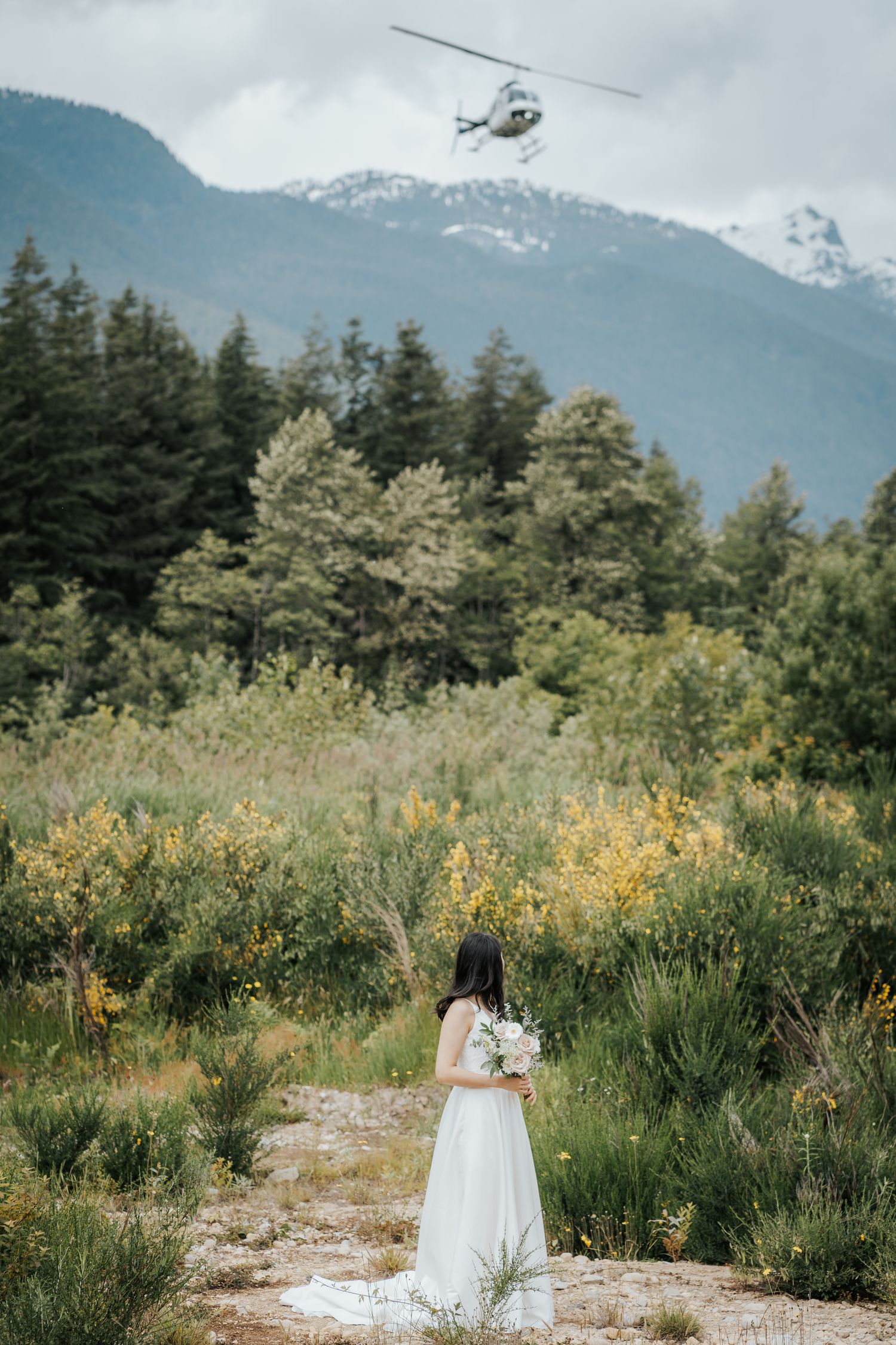 Romantic heli weddportrait overlooking mountains in British Columbia