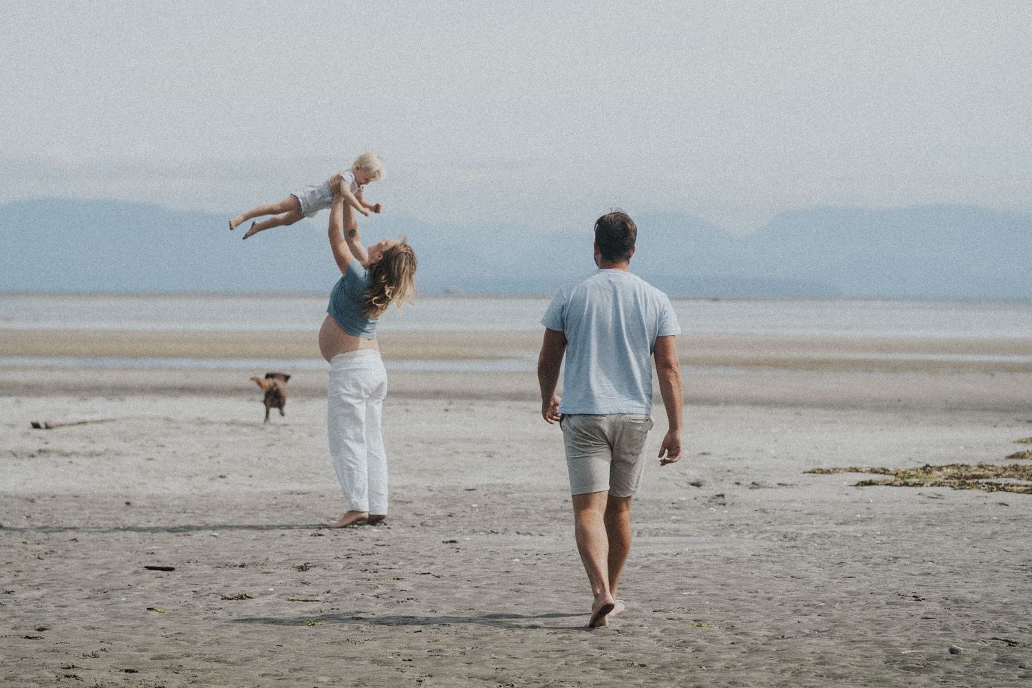 Mother holding baby during outdoor lifestyle photography session in Vancouver