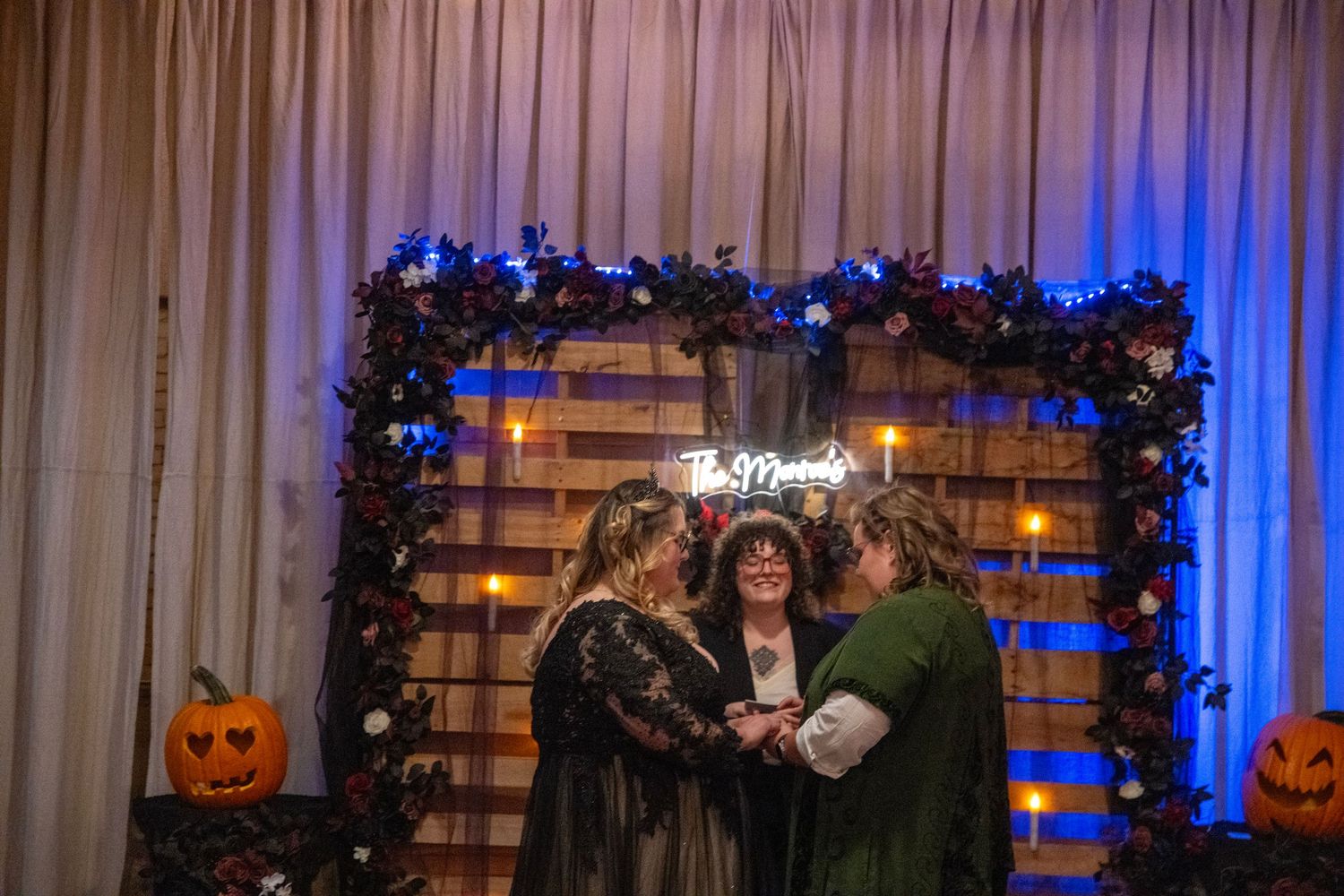 Wedding ceremony space featuring autumn decor, blue uplighting and romantic ambiance.
