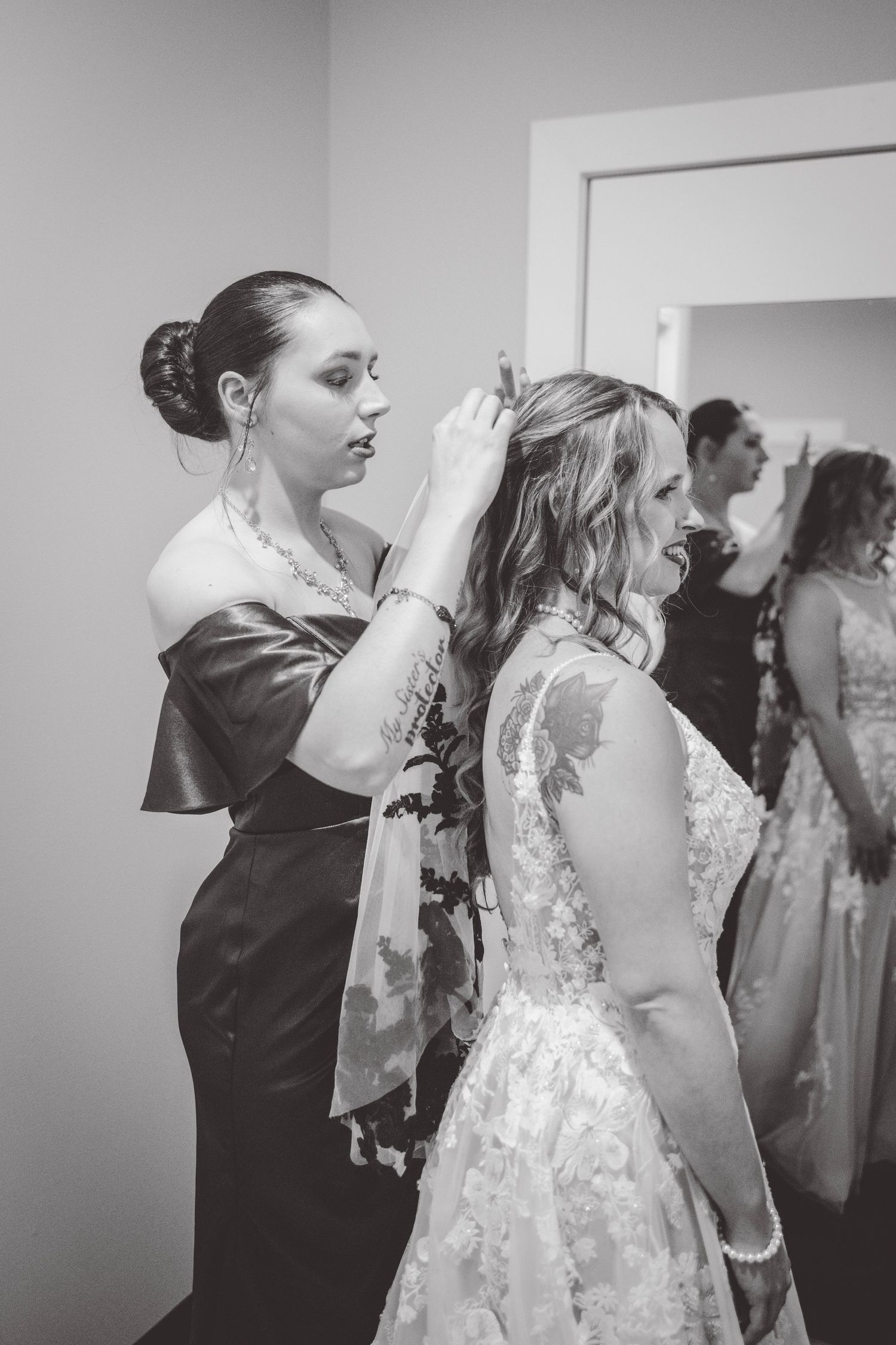 Wedding preparations showing the final touches being made to a bridal gown.