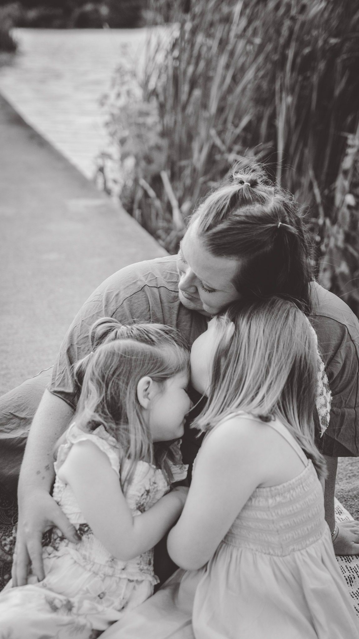 Black and white photo series showing tender moments shared on a garden path.