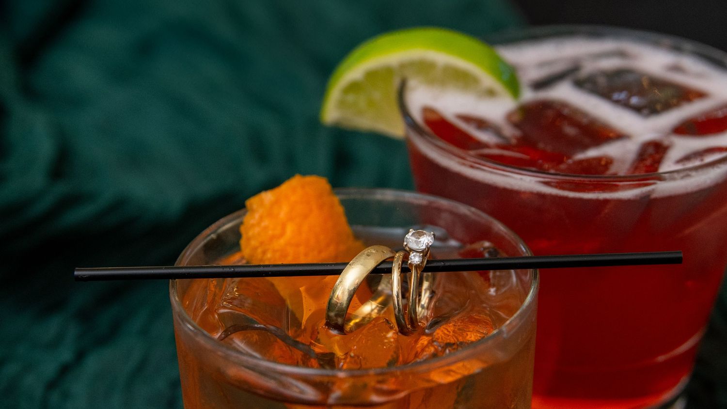 Colorful wedding cocktails garnished with citrus on dark background.