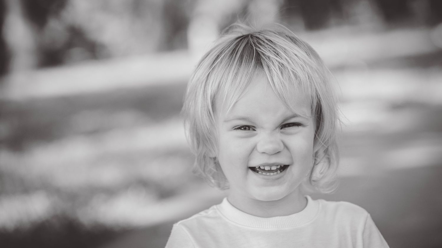 Series of black and white close-up portraits showing joyful expressions.