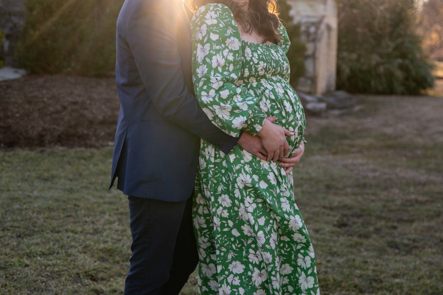 Intimate couple's portrait session at sunset with a green floral dress and navy suit.